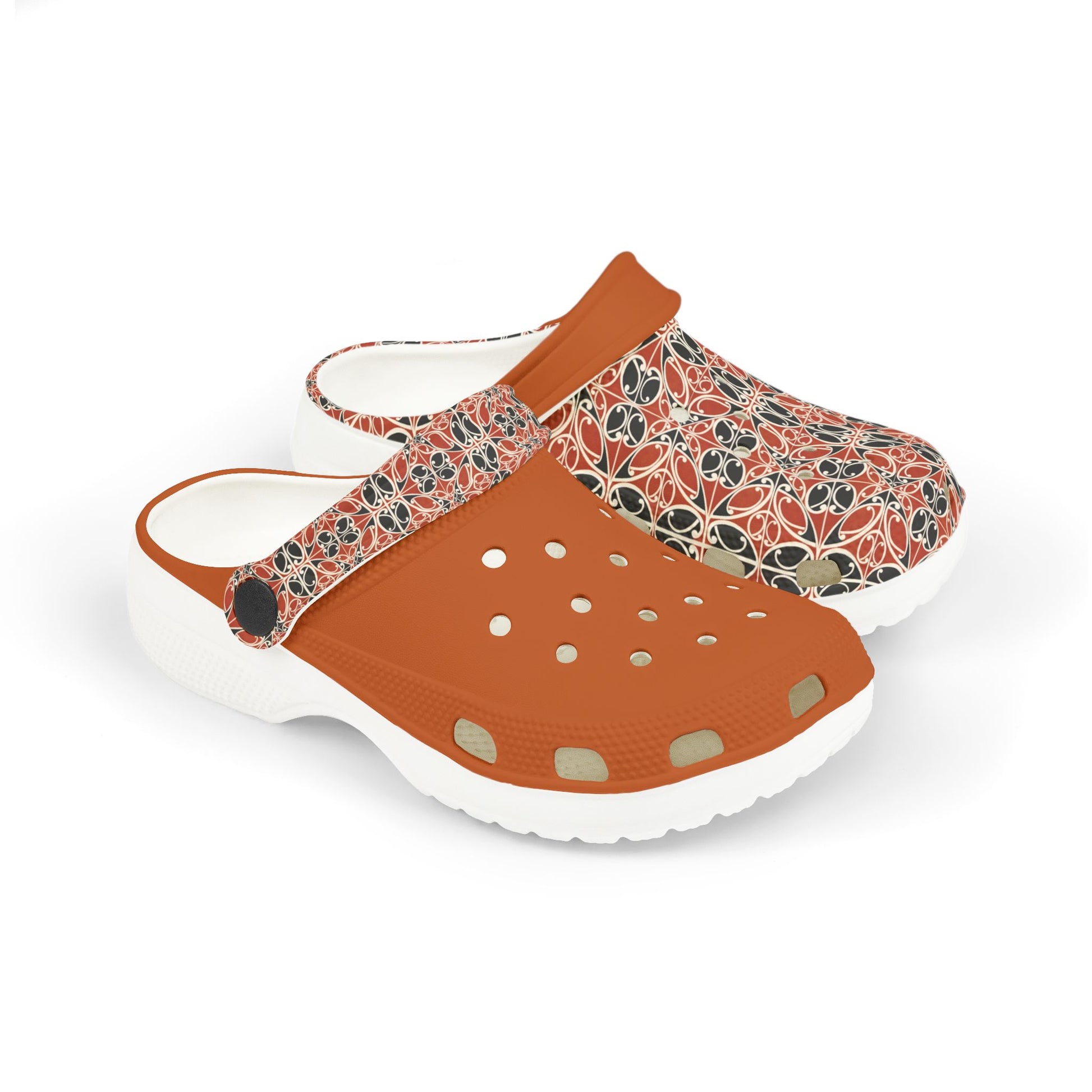 Māoritanga slide clogs with patterned upper, tan strap, and white cushioned sole