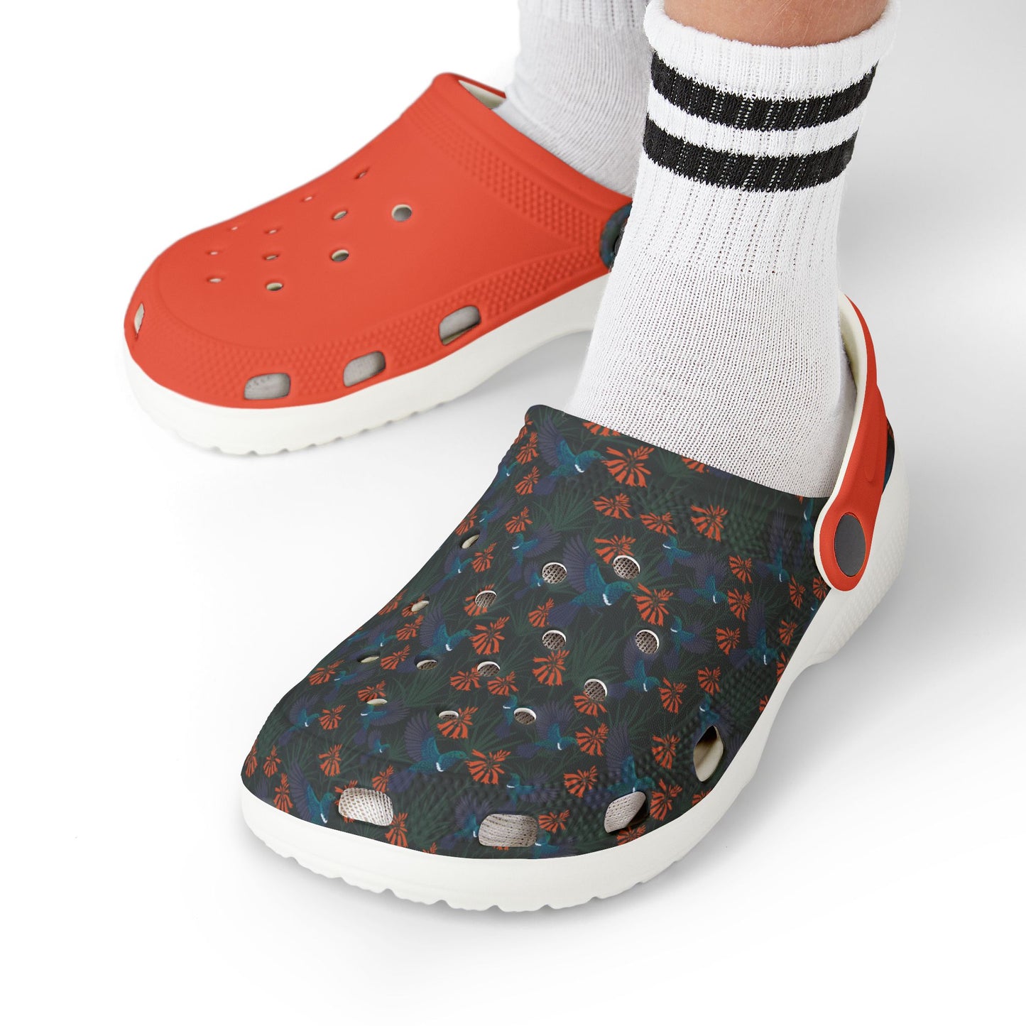Kids slip-on clogs on feet with striped socks, orange top and dark floral back, white sole