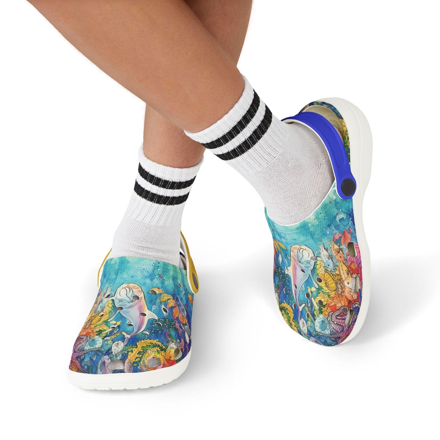 Kids slip-on reef print clogs worn with black-striped white socks; blue side strap visible.