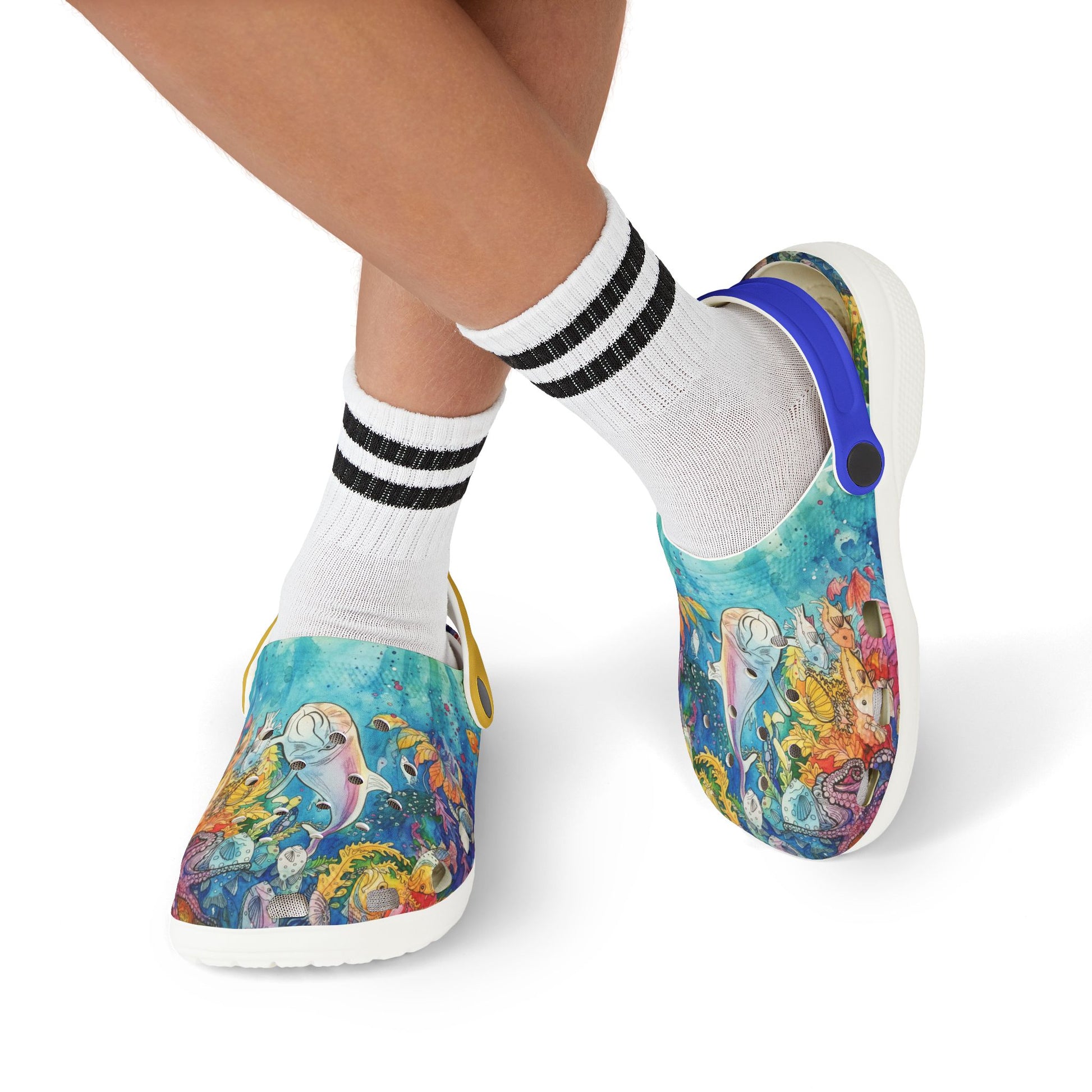 Kids slip-on reef print clogs worn with black-striped white socks; blue side strap visible.