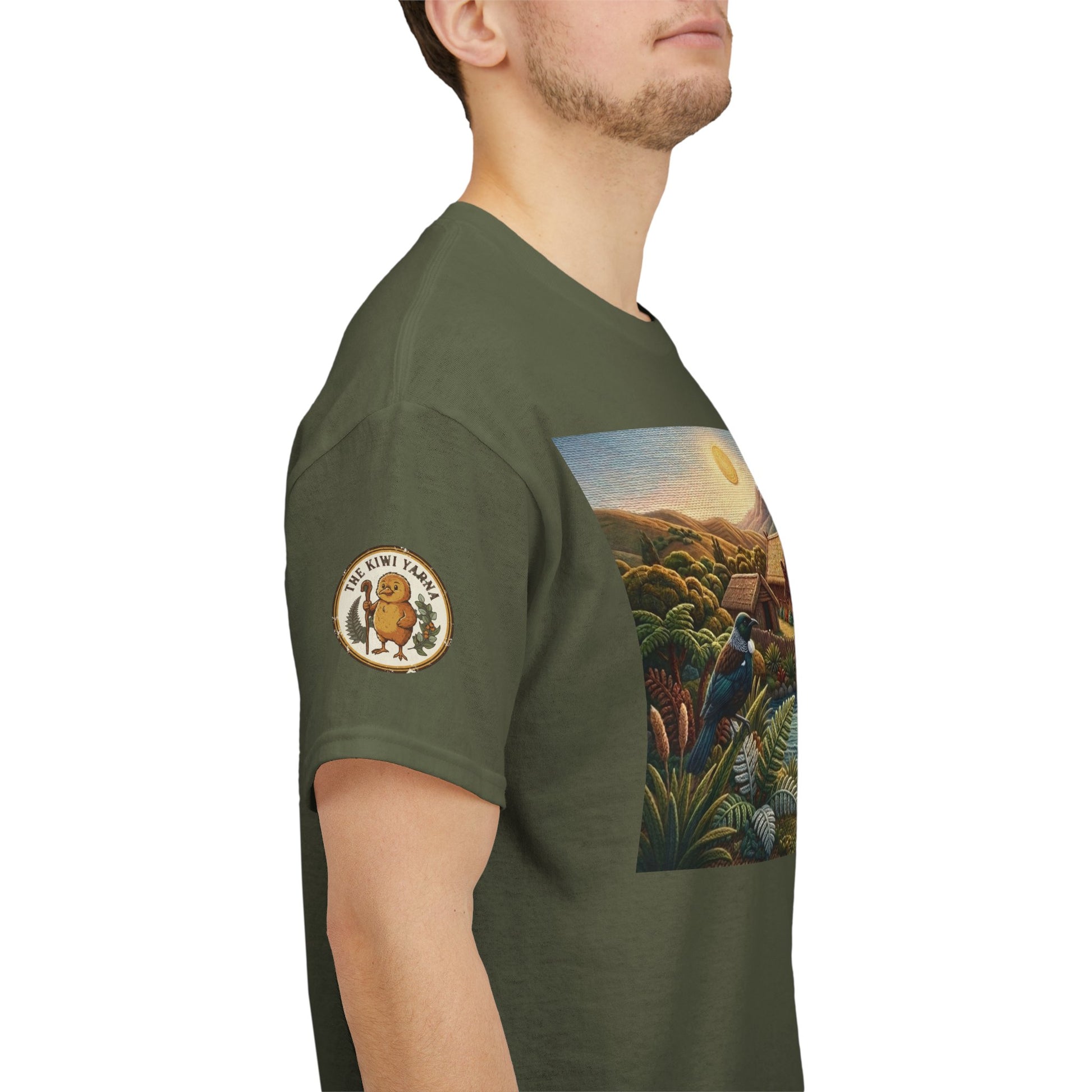 Olive green T-shirt side view with circular sleeve logo patch and partial landscape graphic