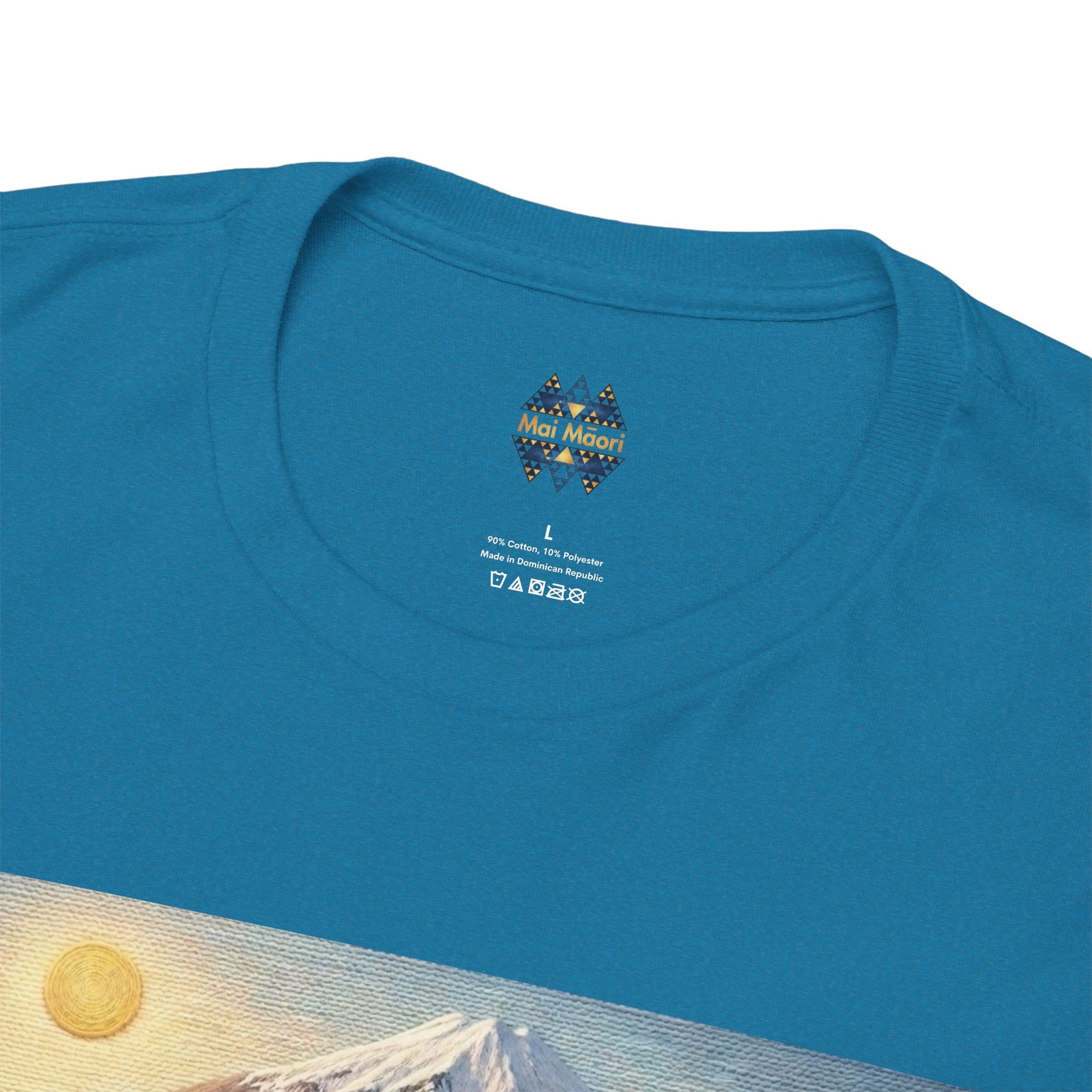 Teal T-shirt close-up with small chest logo and landscape print edge
