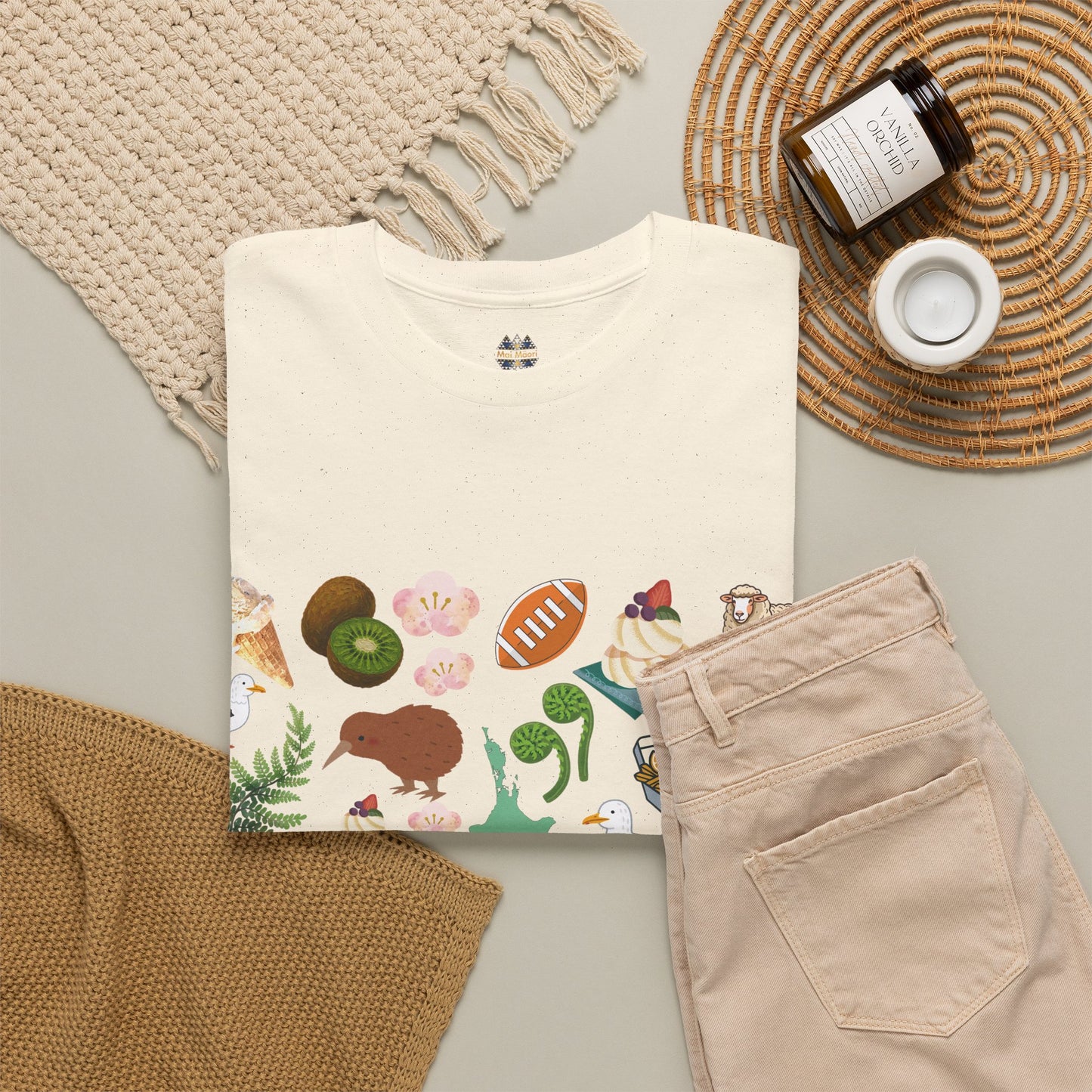 Cream crewneck T-shirt with colorful illustrated hem graphic featuring kiwi, flowers, and shells