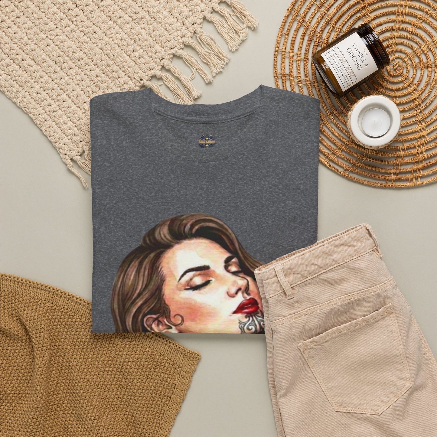 Heather gray graphic T-shirt folded flat with woman face portrait print visible.