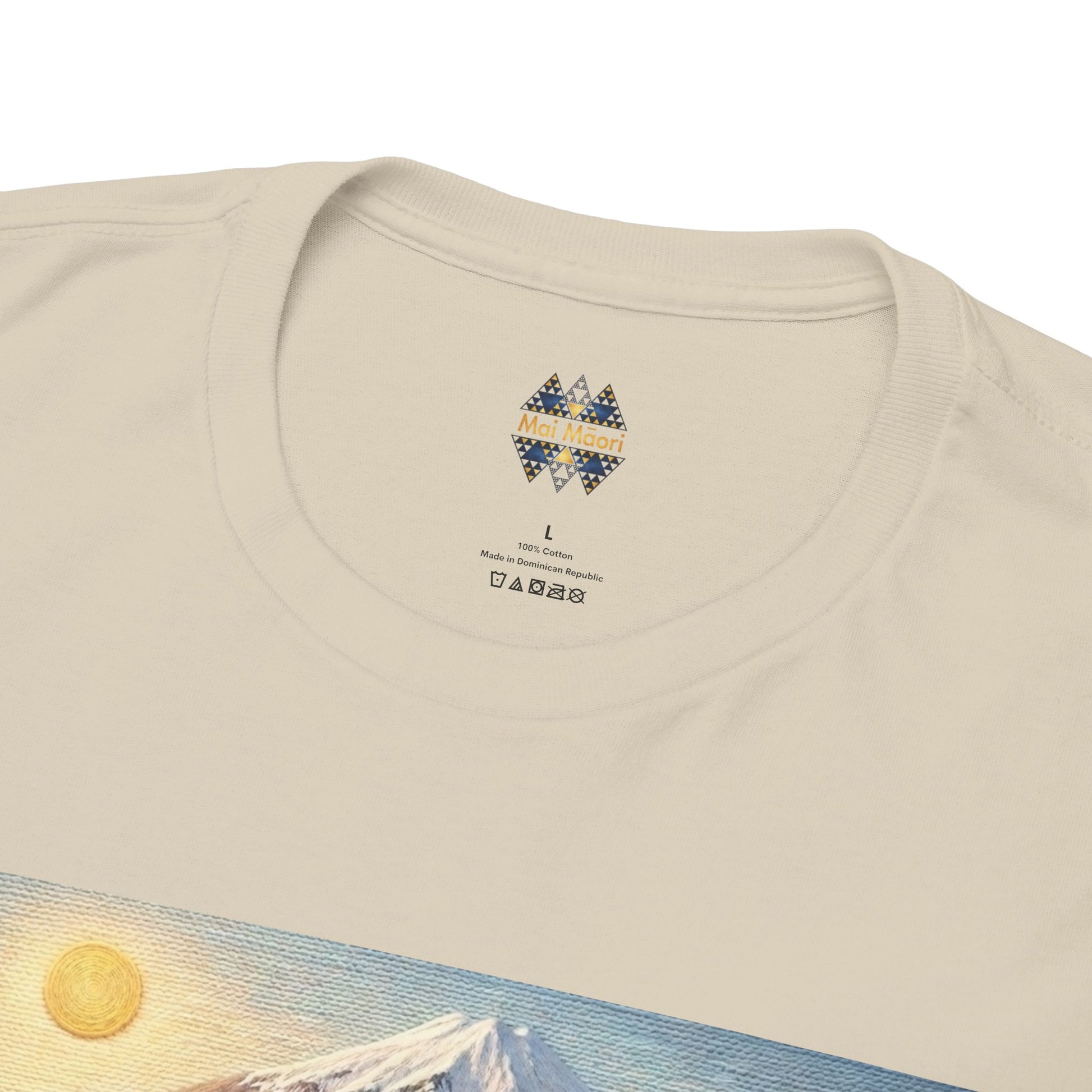 Cream t-shirt with small chest emblem near crew neck, landscape print partly visible