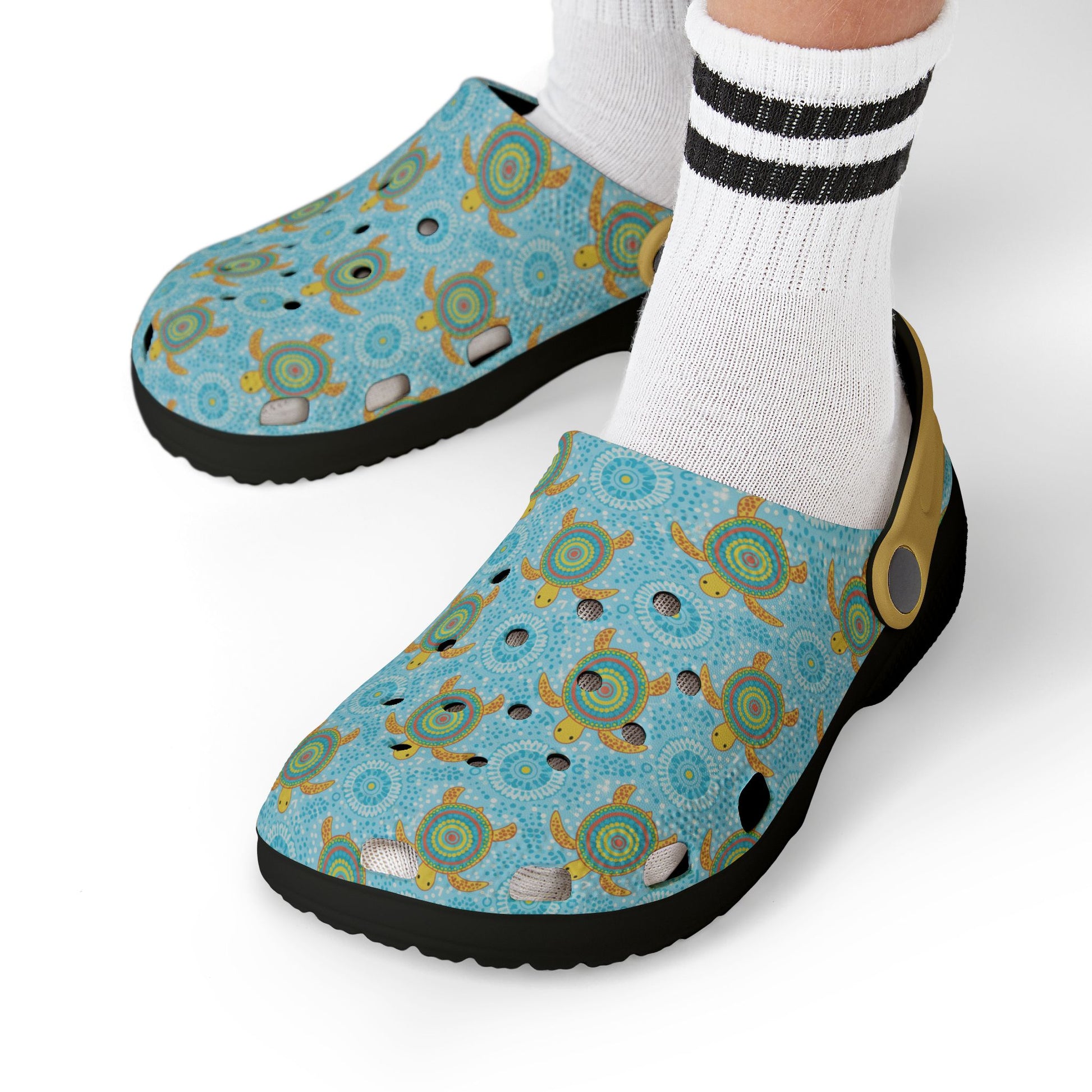 Blue patterned clog shoes worn with white socks featuring bold black stripes