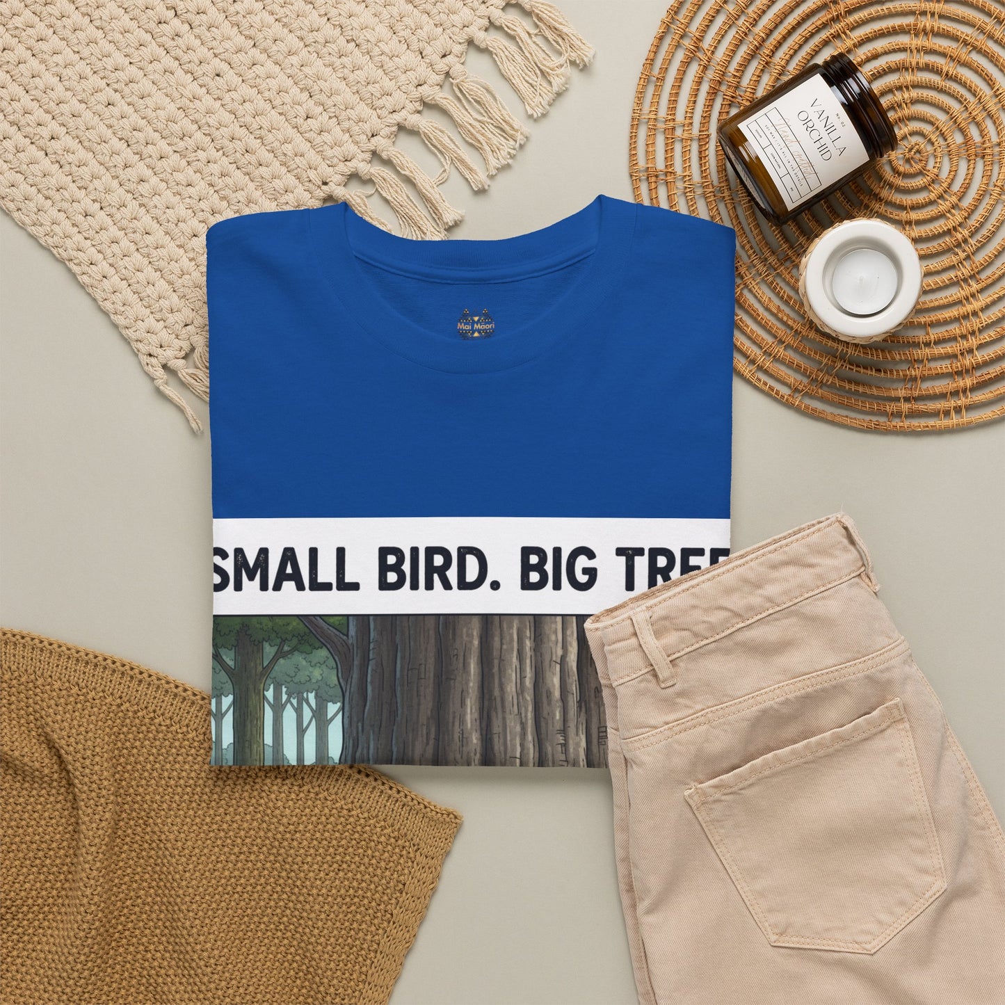 Blue crew-neck T-shirt on display, showing “Small Bird. Big Tree.” front print