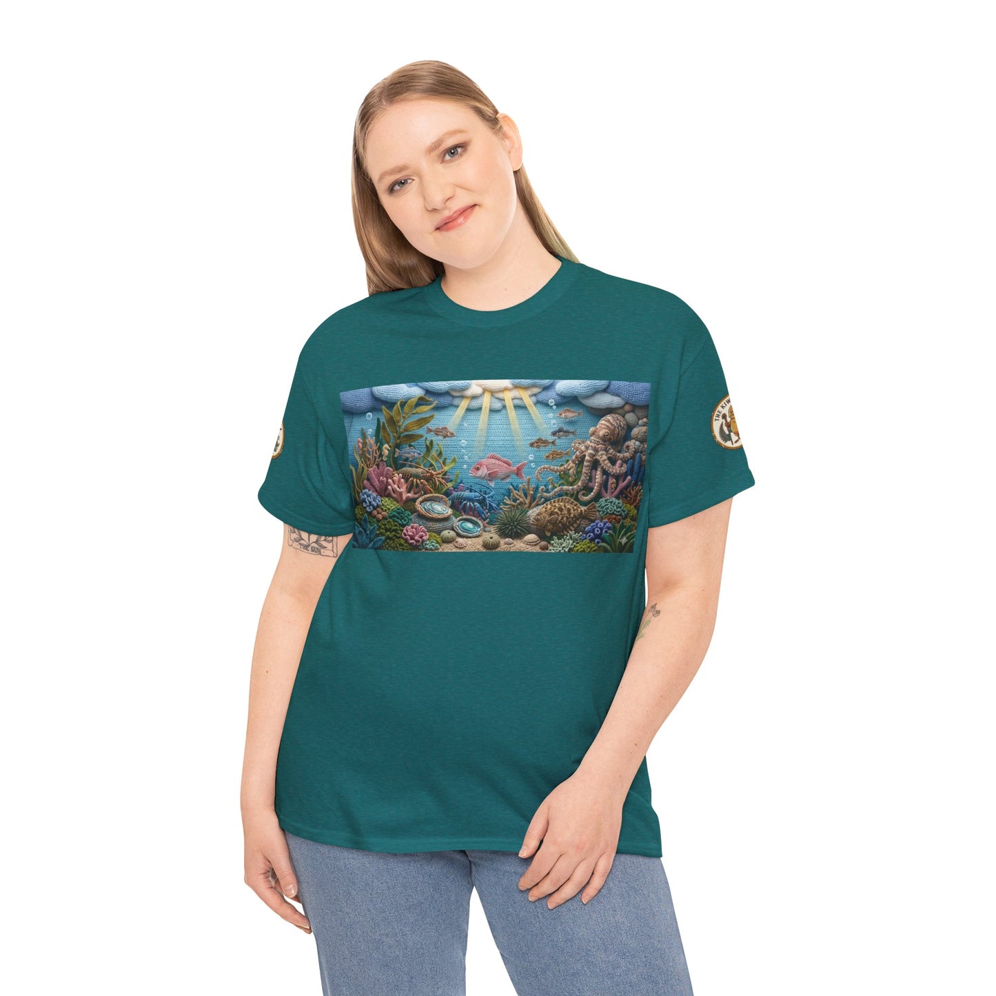 Teal short-sleeve T-shirt worn by a model, featuring an undersea chest graphic