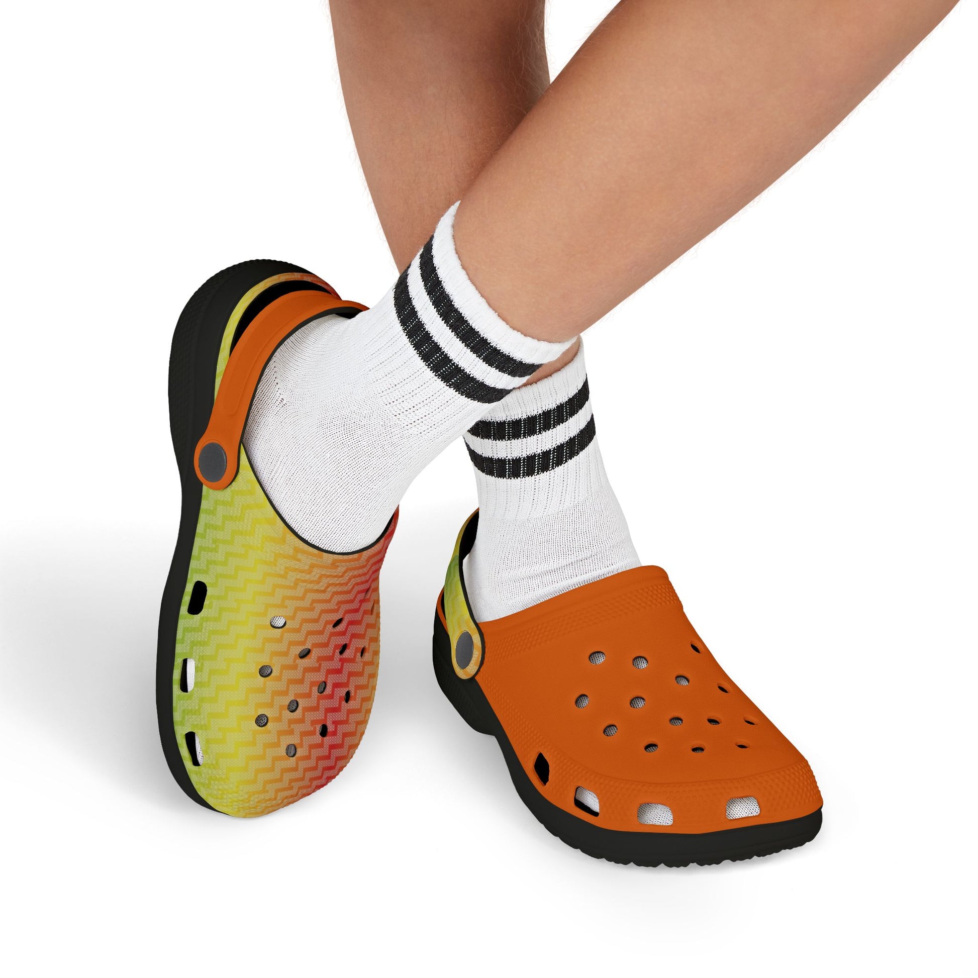 Orange clogs with perforated upper and lime zigzag side panel, worn with white socks.