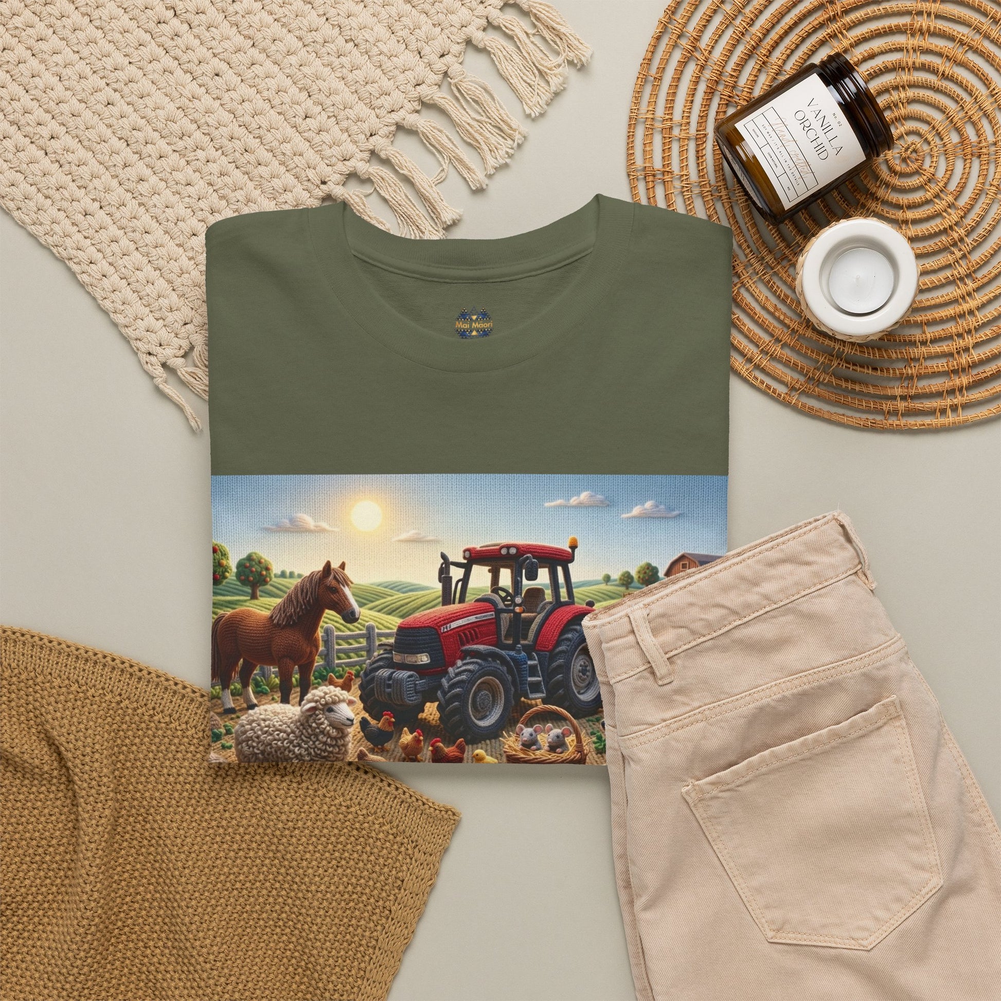 Olive T-shirt with farm tractor graphic, shown folded with beige pants.