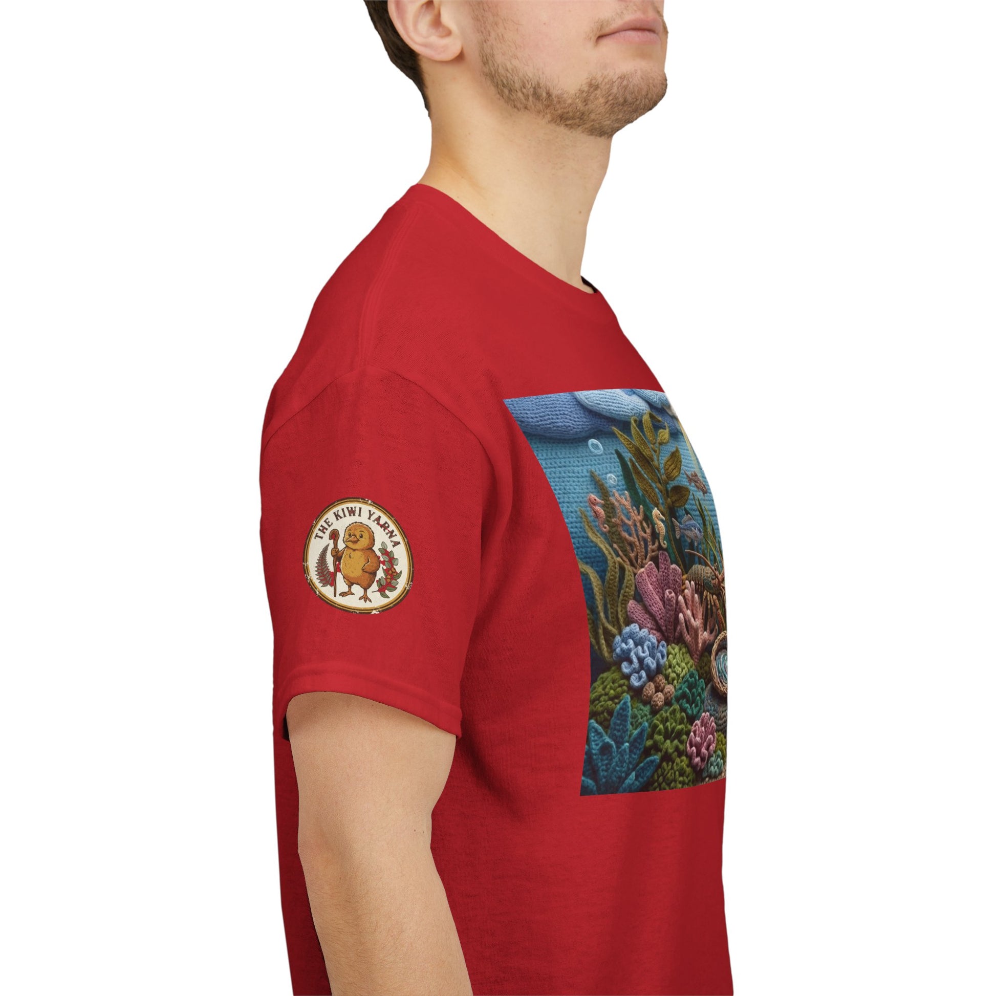 Red T-shirt with underwater scene print panel and circular patch on the sleeve.