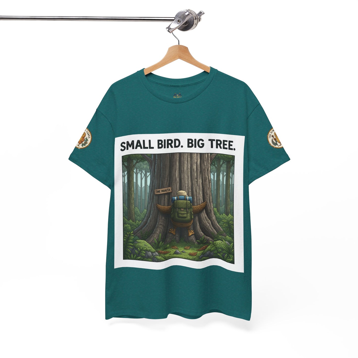 Teal crew-neck T-shirt on hanger with centered white-framed forest scene and sleeve patches
