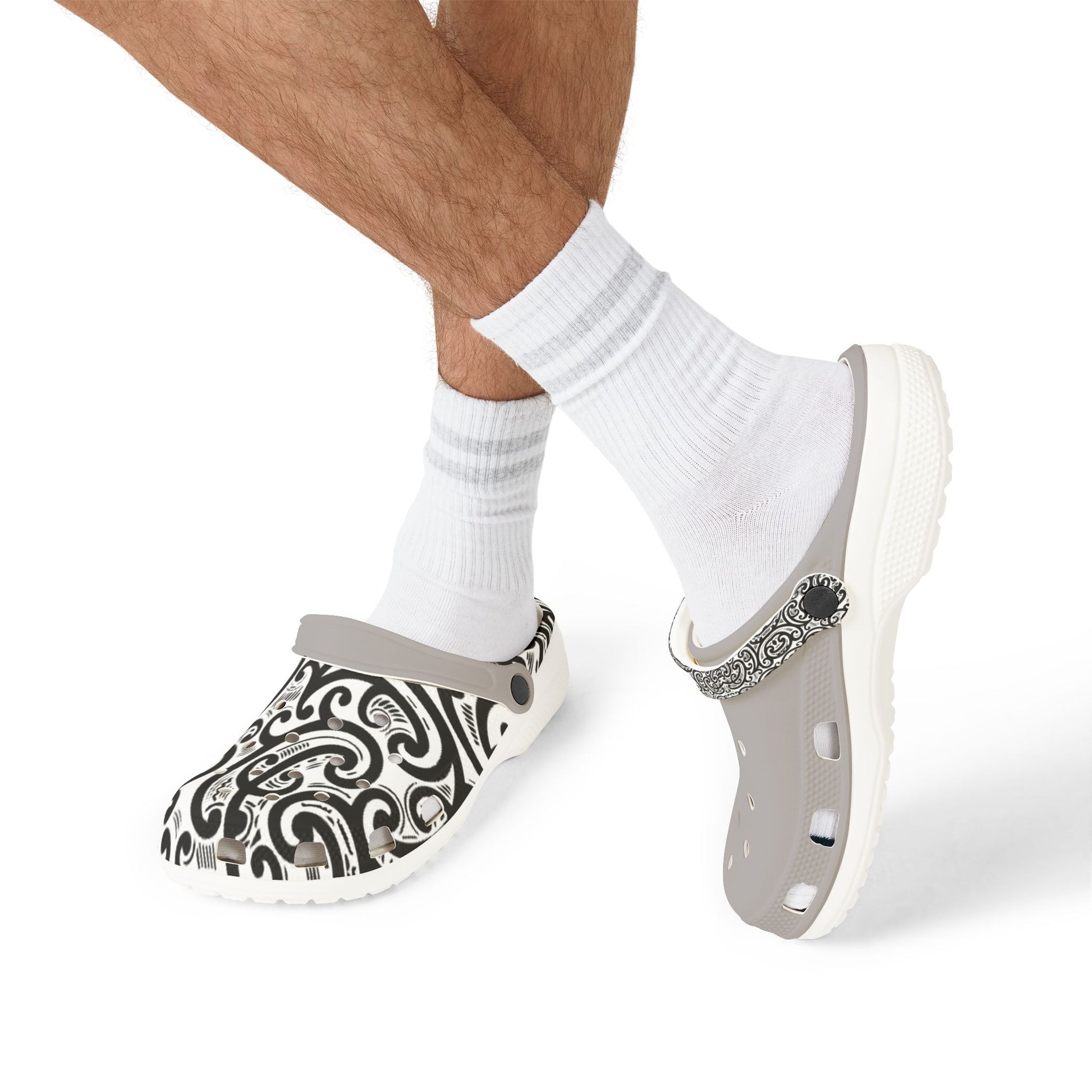 Ponga clogs on white socks, gray base with black-and-white paisley upper and strap