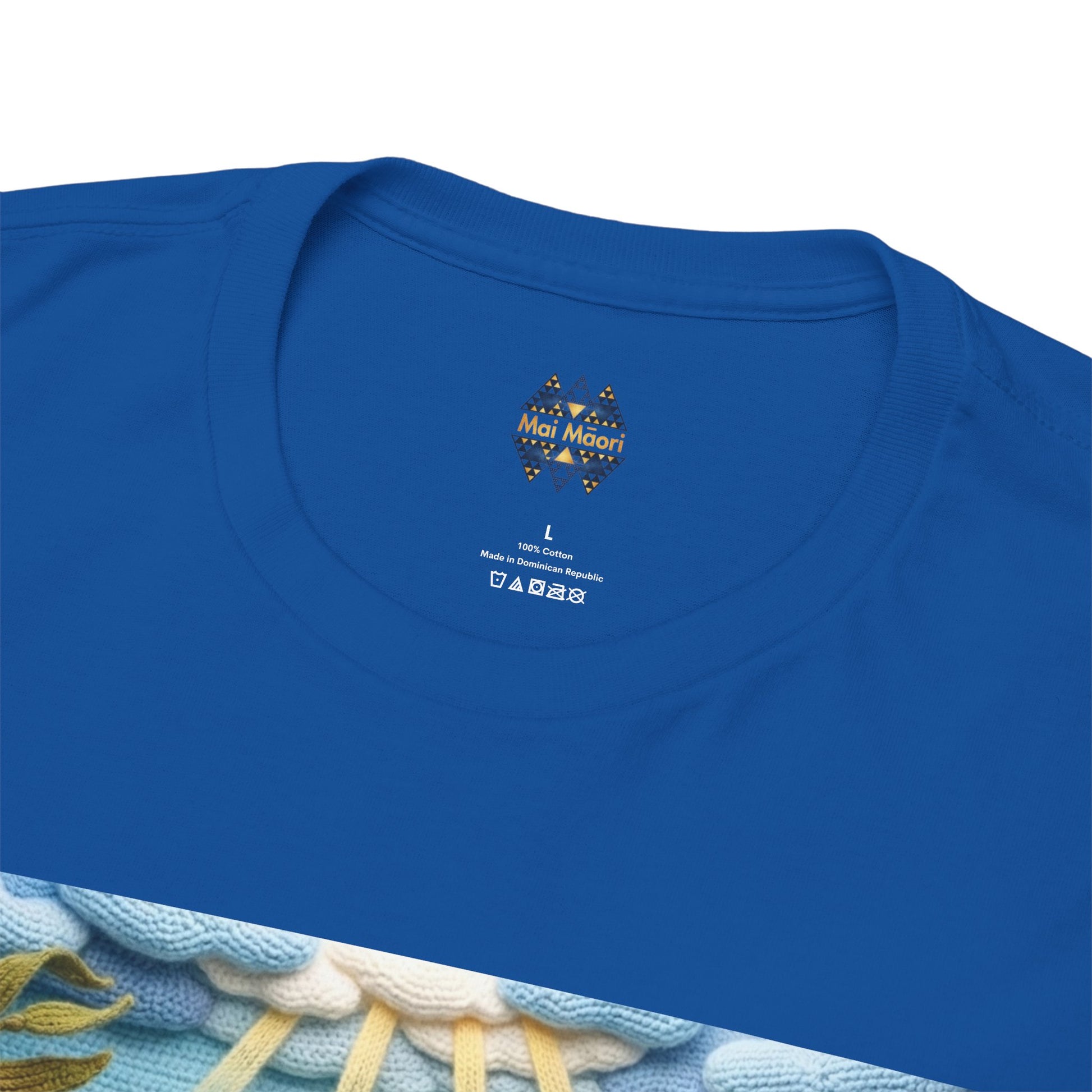 Blue T-shirt chest close-up with small emblem near the crew neckline