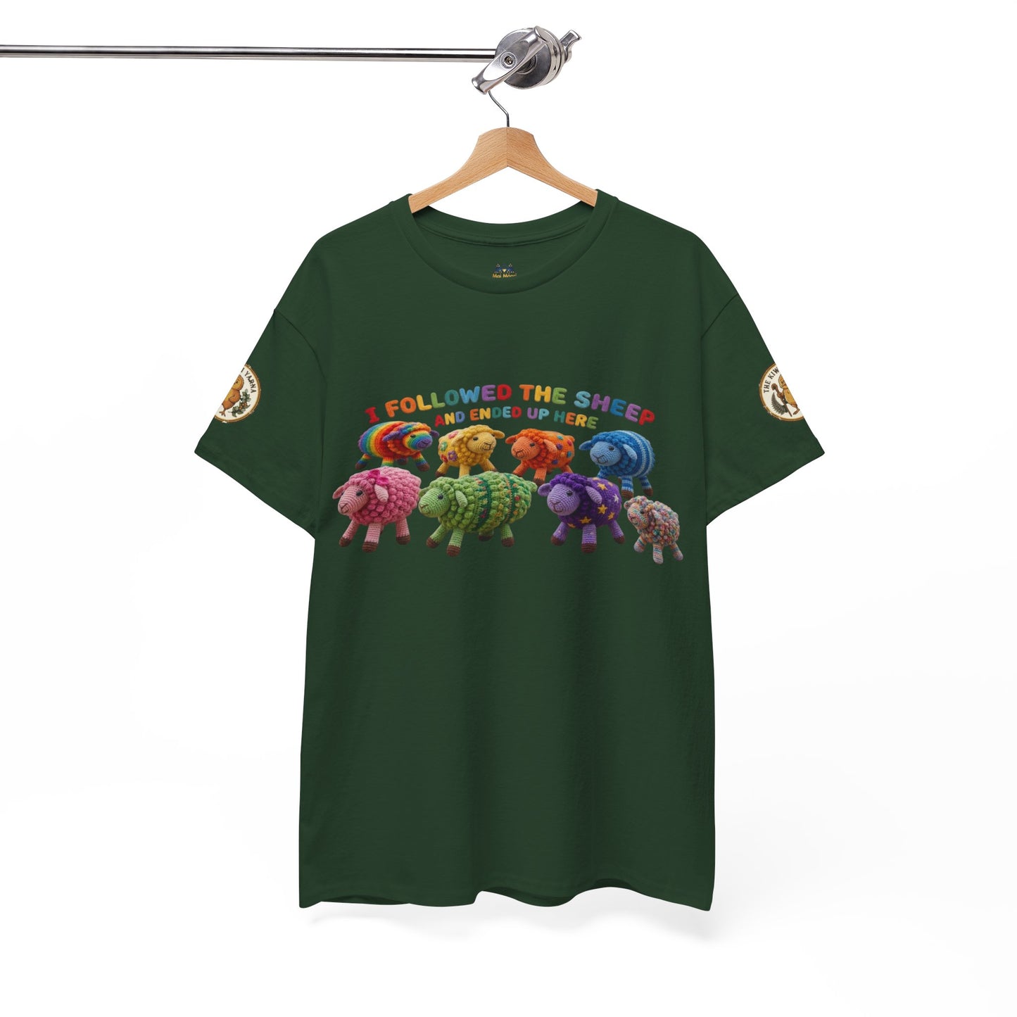 Forest green graphic T-shirt on a hanger with colorful sheep scene at center