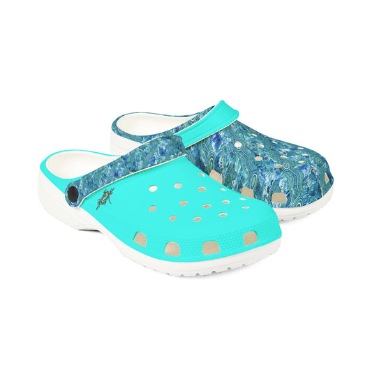 Teal and blue patterned clog shoes with perforated top and strap detail, white soles