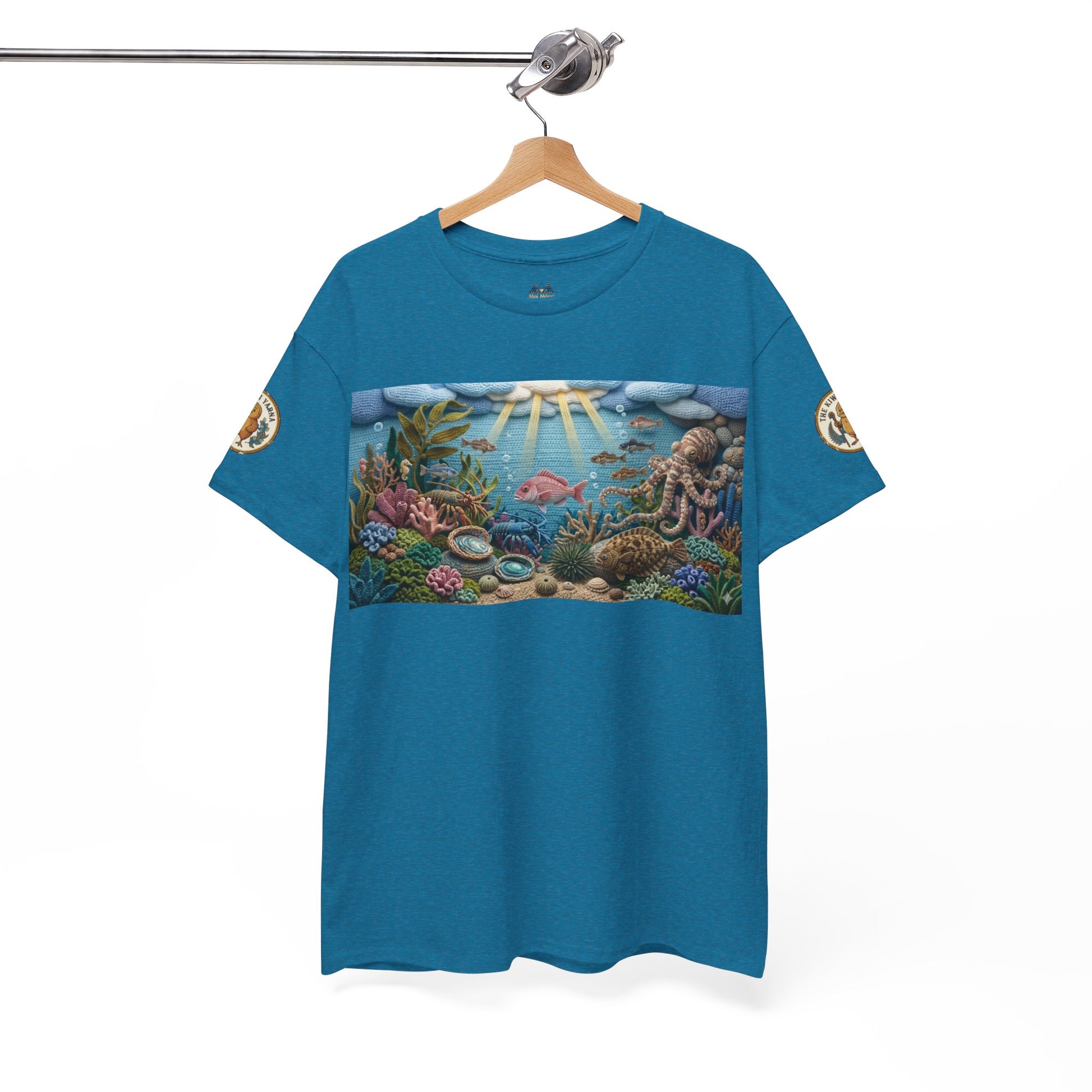 Teal/blue ocean graphic T-shirt hanging with coral reef chest print and sleeve patches