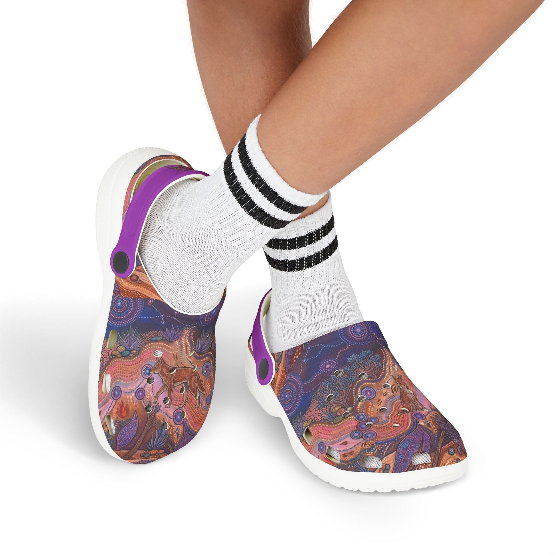 Patterned clog shoes worn with white socks and black-and-white striped cuffs