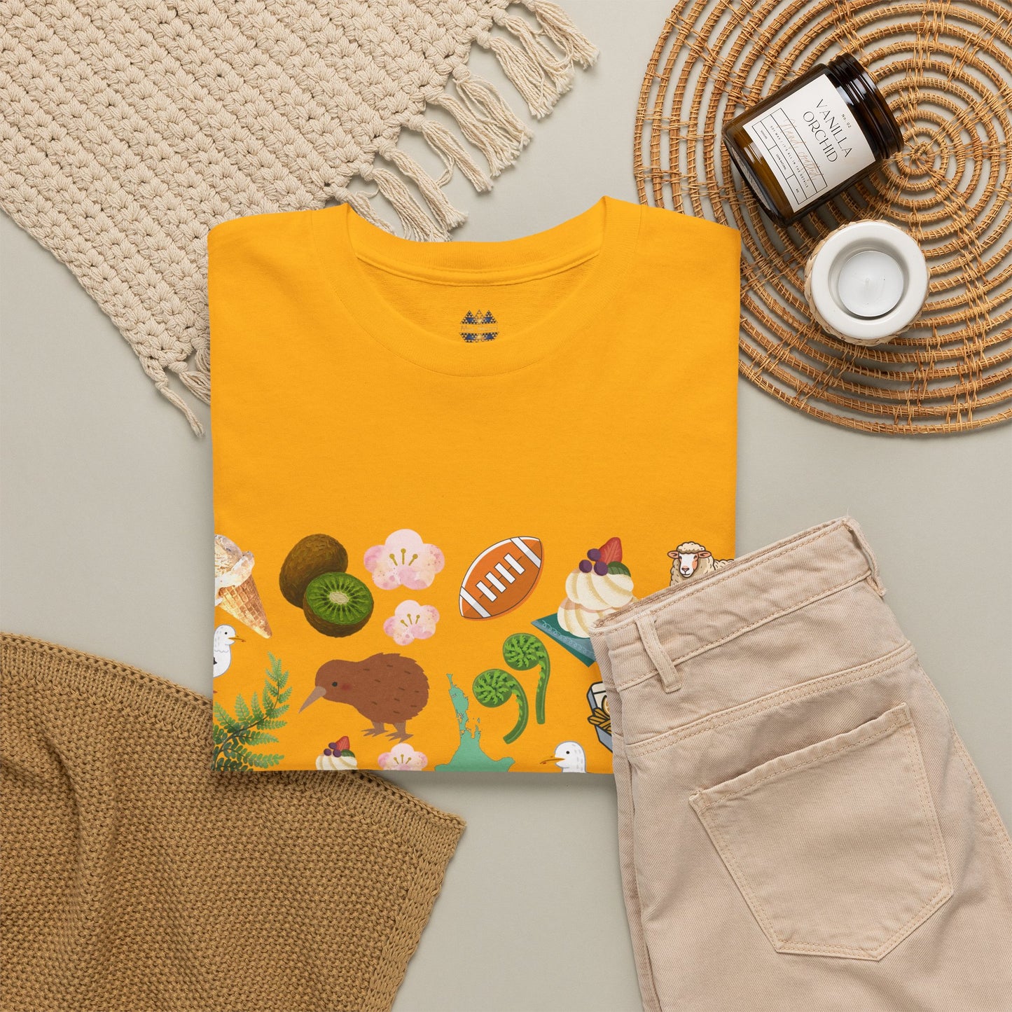 Mustard yellow T-shirt with crew neck and Kiwiana animals and native-food print on front.
