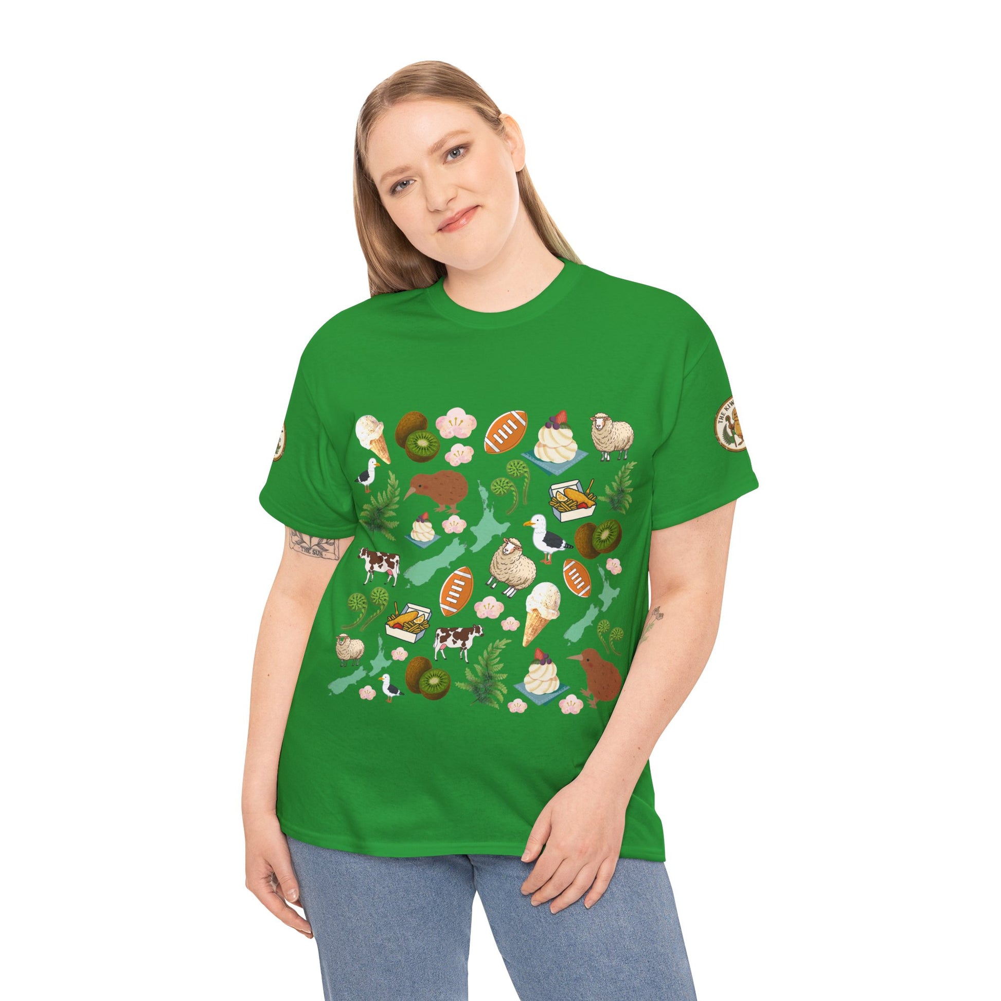 Green crewneck T-shirt on model, featuring scattered Kiwiana-themed icons and animals (front)