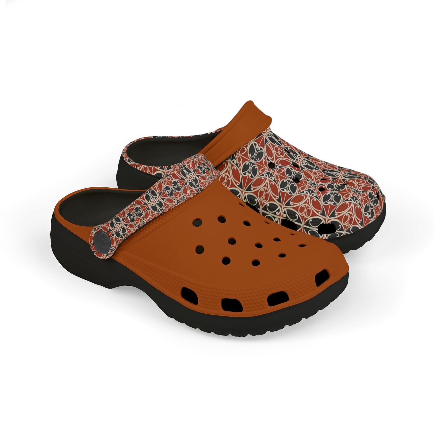 Māoritanga slide clogs with patterned upper, tan strap, and black cushioned sole