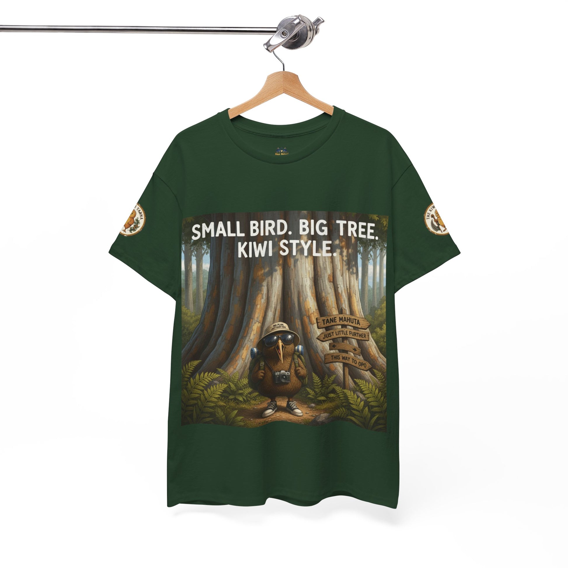 Dark green t-shirt on hanger with front graphic: Small Bird Big Tree Kiwi Style