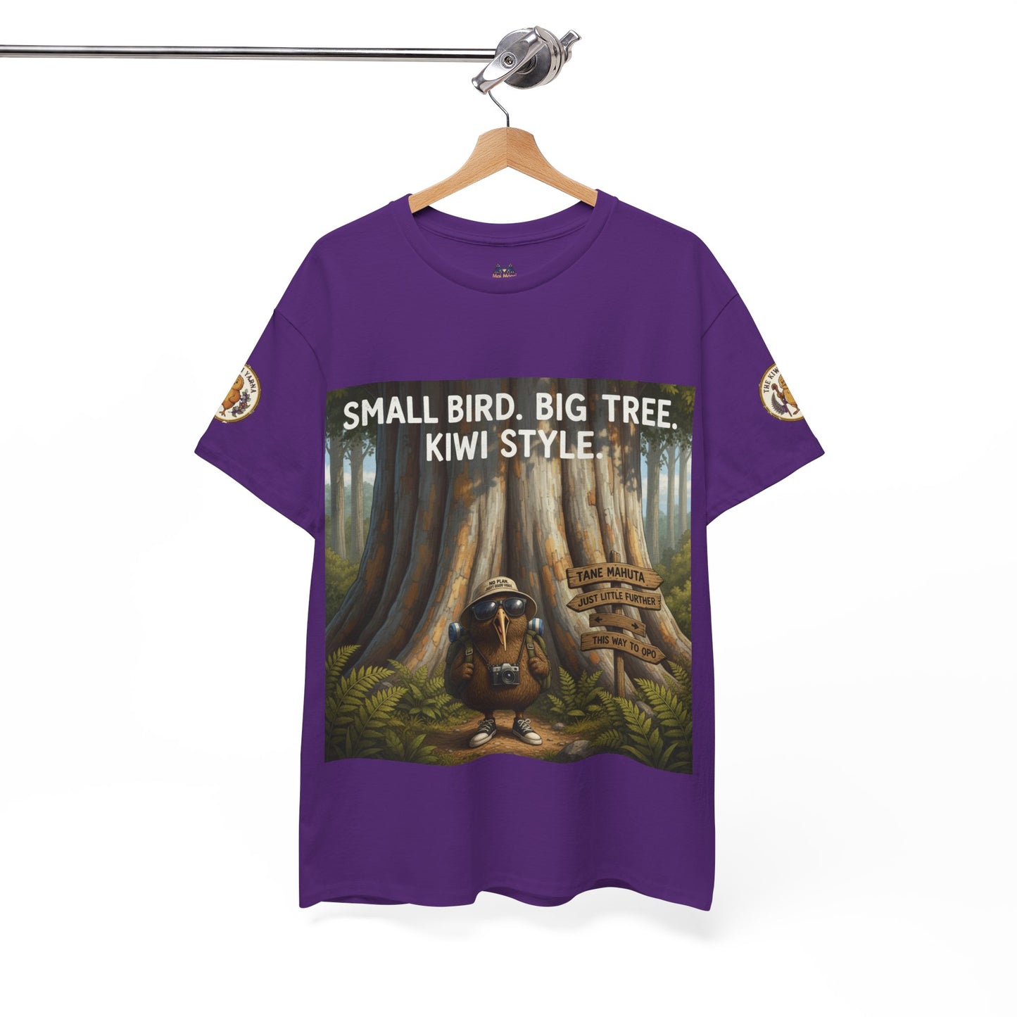 Purple graphic t-shirt with framed tree and kiwi-style artwork on the front