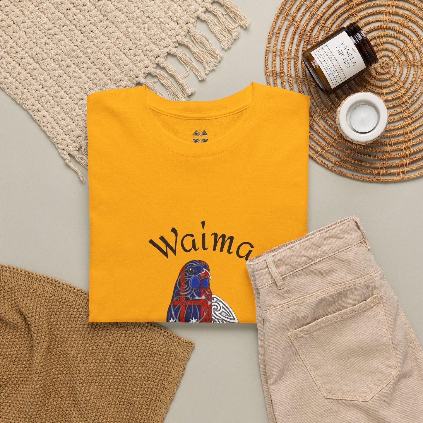 Yellow short-sleeve T-shirt with Waima bird graphic on front