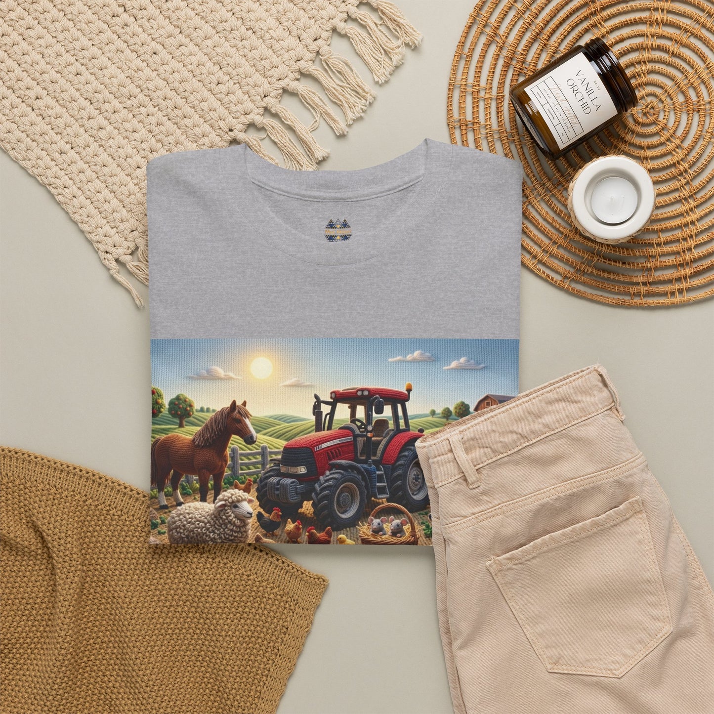 Natural beige T-shirt with farm scene graphic and small chest emblem, folded flat lay