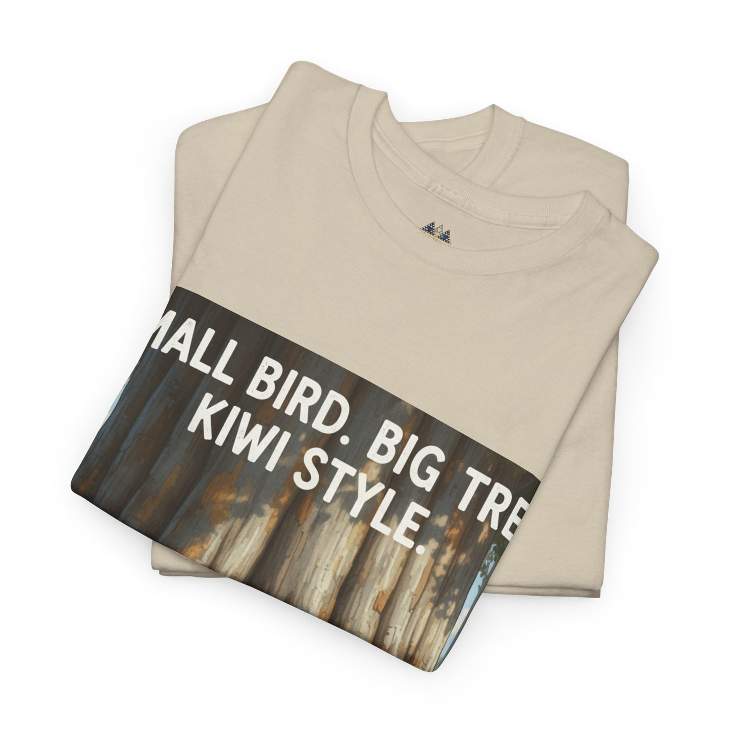 Beige folded T-shirt with large 'Small Bird. Big Tree. Kiwi Style' graphic