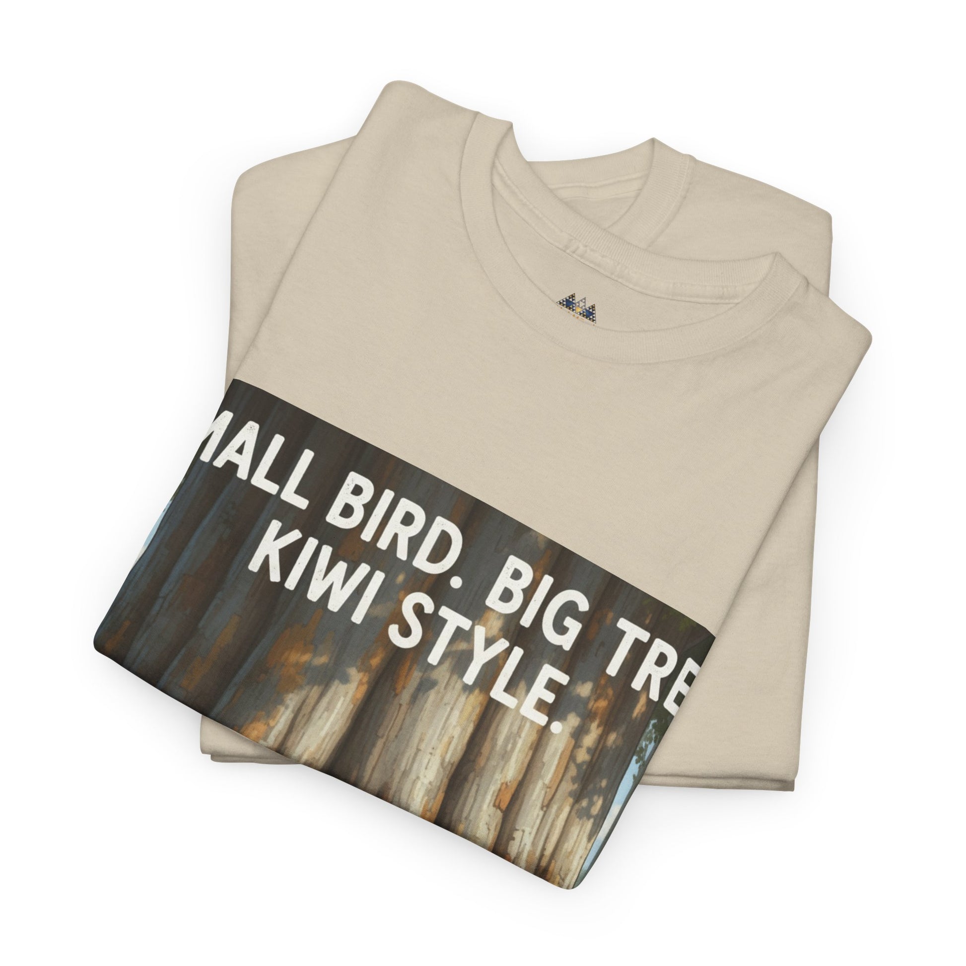 Beige folded T-shirt with large 'Small Bird. Big Tree. Kiwi Style' graphic