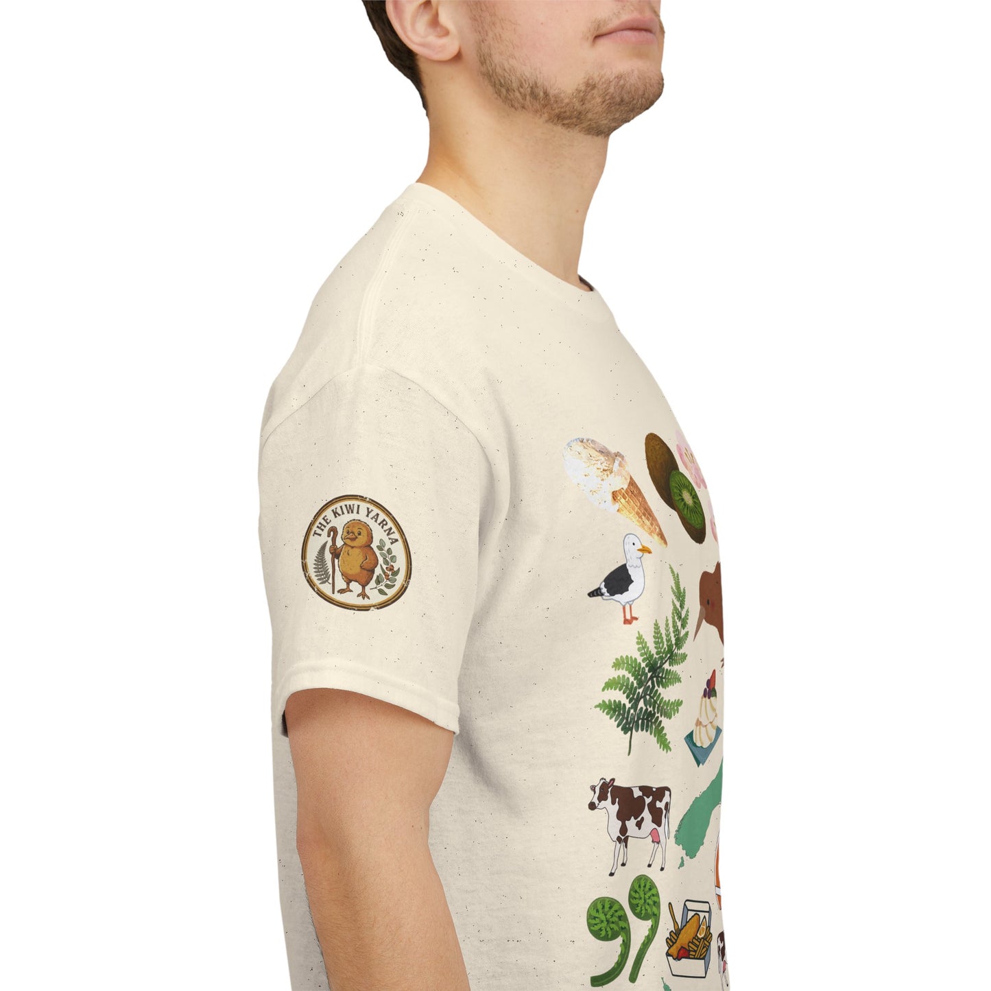 Natural crewneck T-shirt with colorful Kiwiana-themed graphic on sleeve and chest emblem