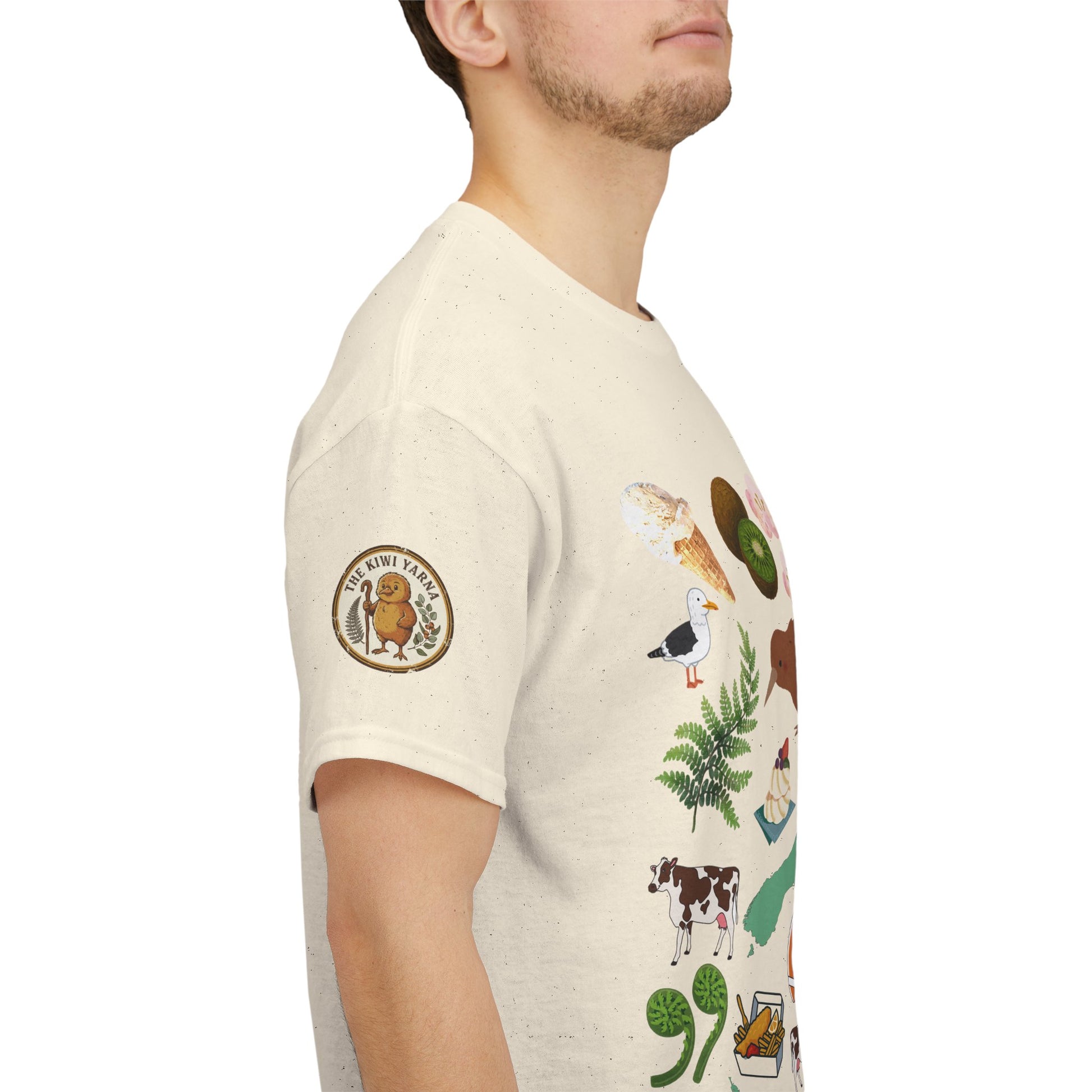 Natural crewneck T-shirt with colorful Kiwiana-themed graphic on sleeve and chest emblem