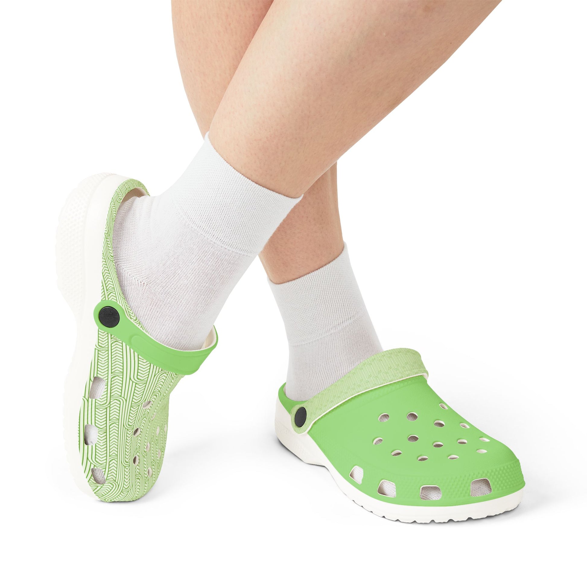 Maoritanga clogs with white socks, green patterned heels and perforated fronts, white sole
