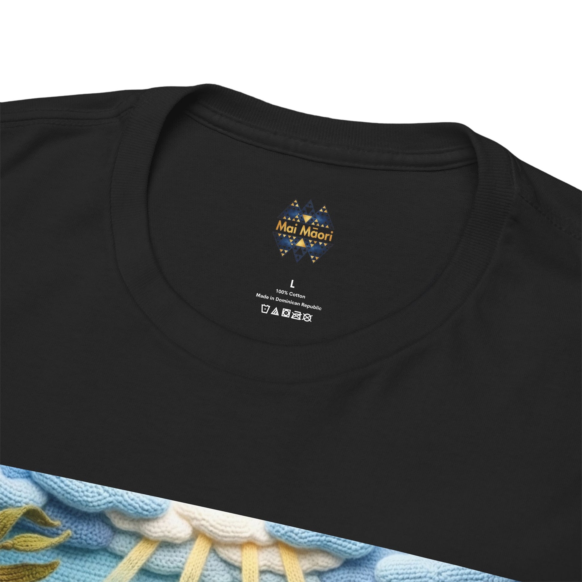 Black T-shirt neckline close-up with small chest logo and size label; underwater print edge visible.