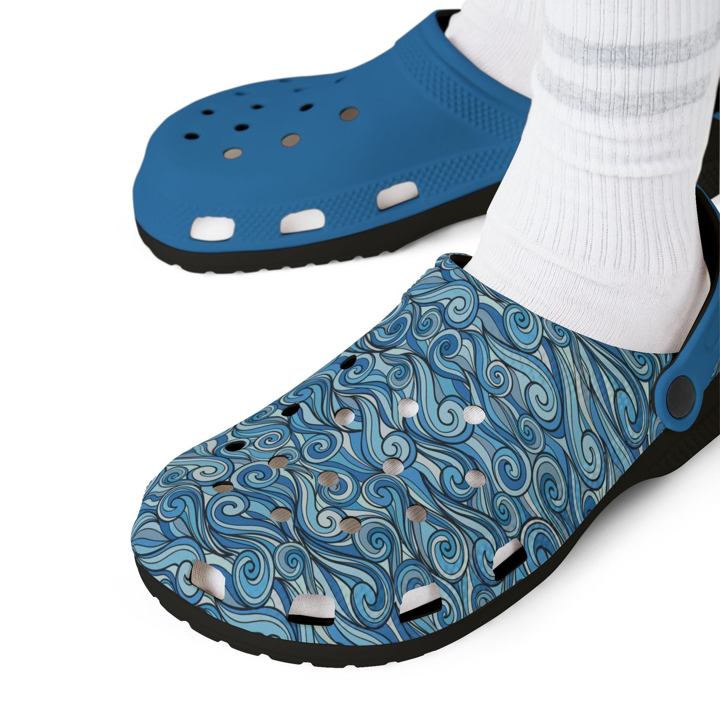 Blue clog sandals with patterned upper and ventilation holes on white socks