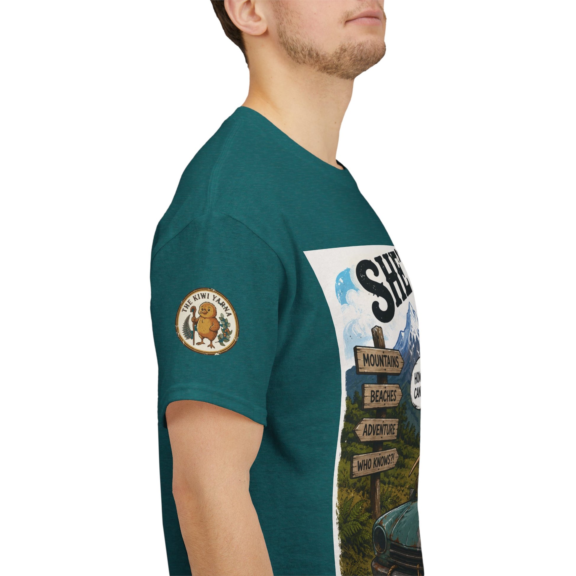 Teal graphic T-shirt with circular emblem patch and partial vehicle print