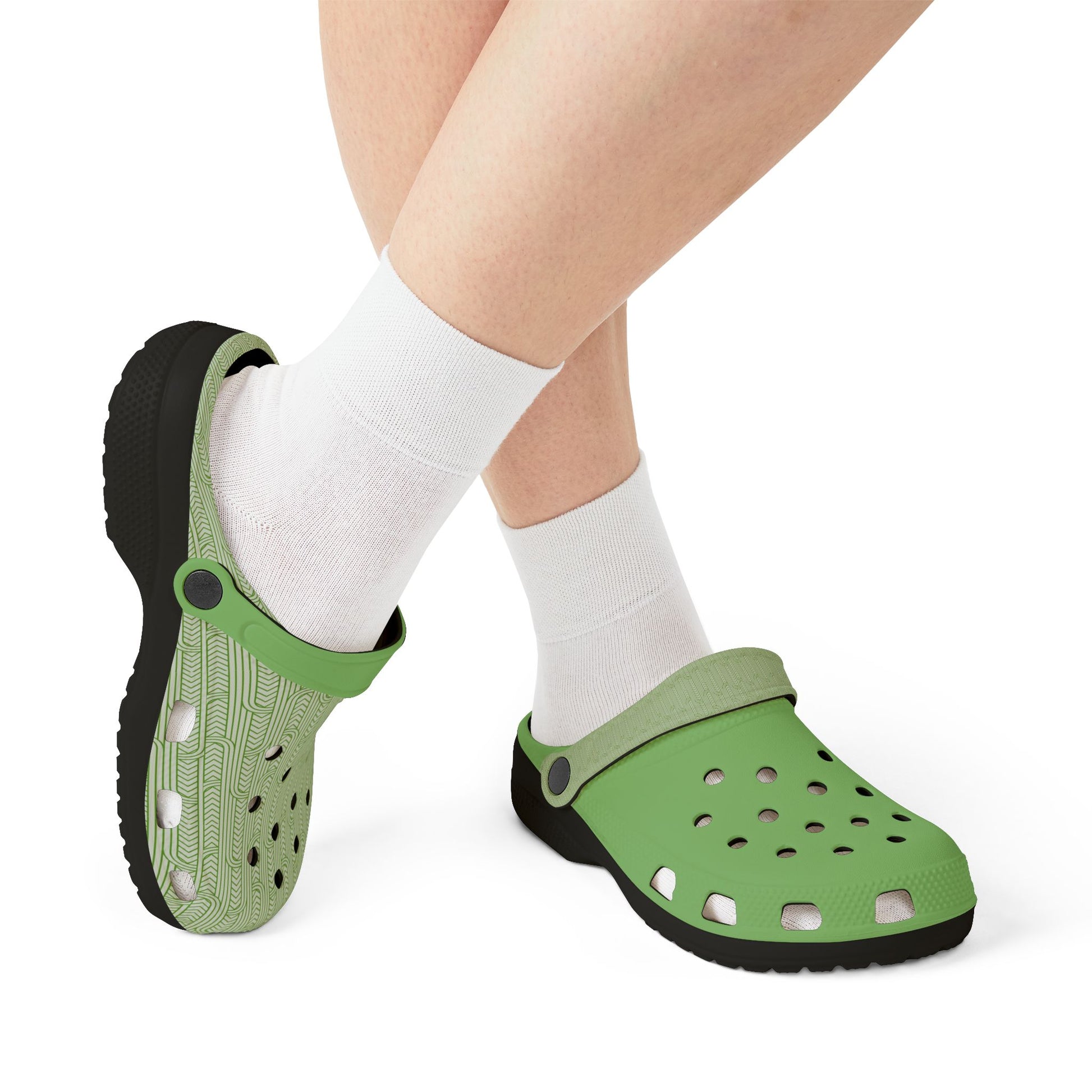 Green clog sandals on feet with white crew socks, black outsole and heel strap