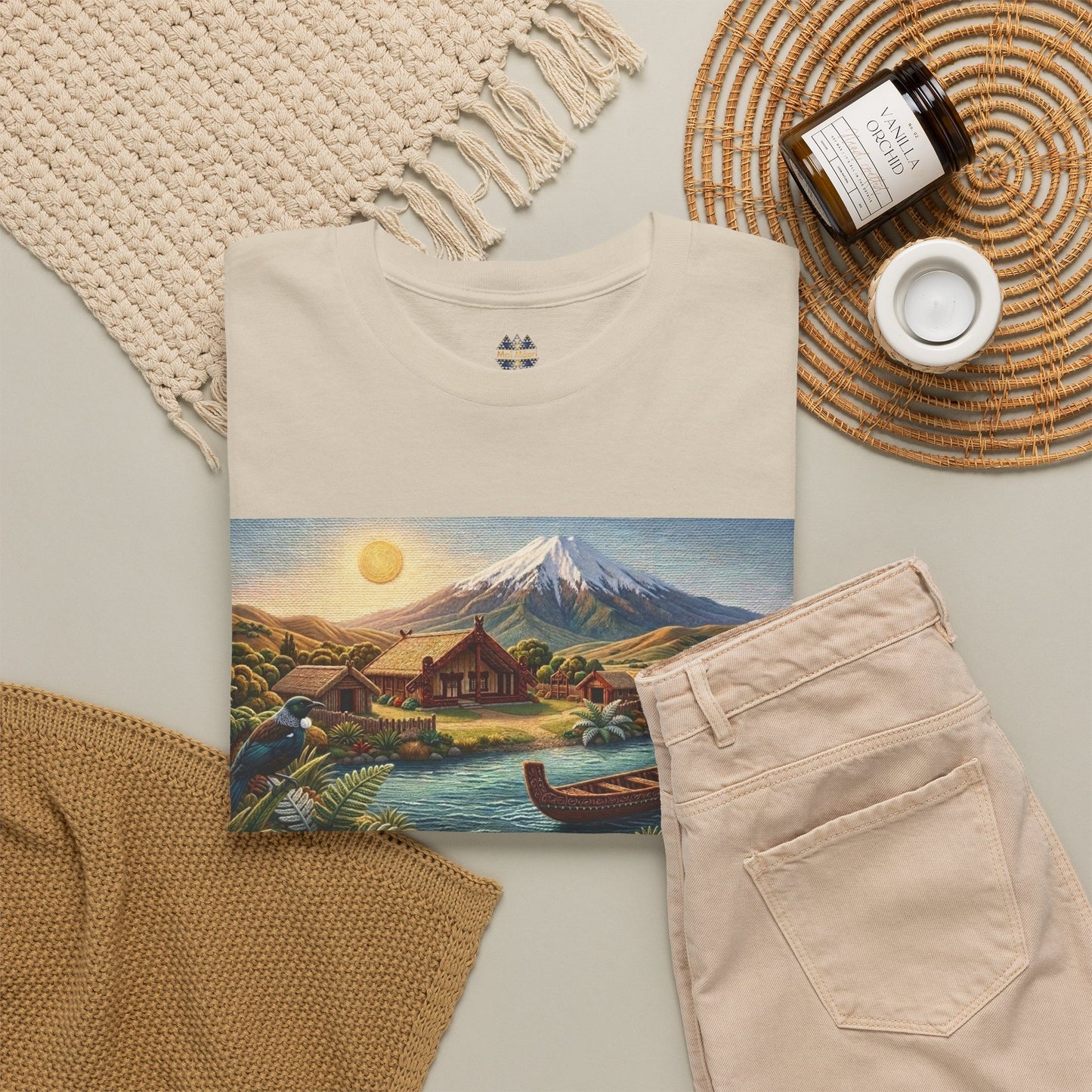 Cream graphic t-shirt with landscape print panel and small chest emblem, flat-lay view