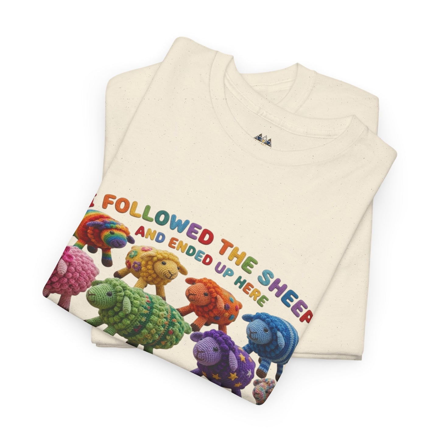 Cream graphic crewneck T-shirt with colorful sheep herd and “I followed the sheep” text.