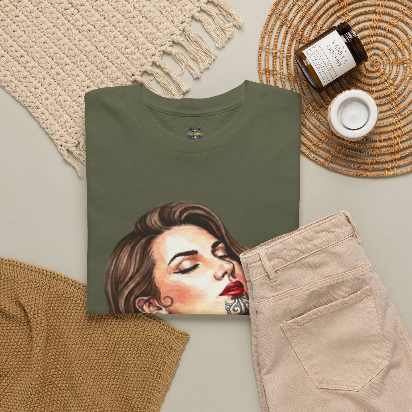 Olive green graphic T-shirt with front portrait print and small logo near collar