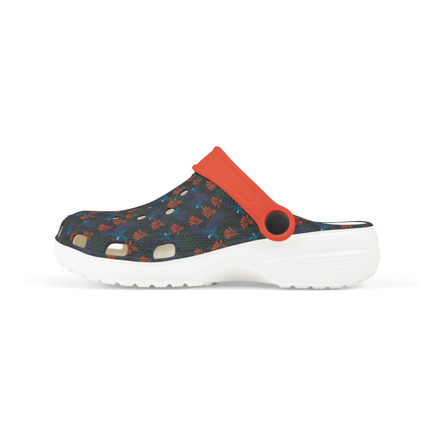 Kids clog shoe side view: dark floral upper with orange heel strap, vent holes, white sole