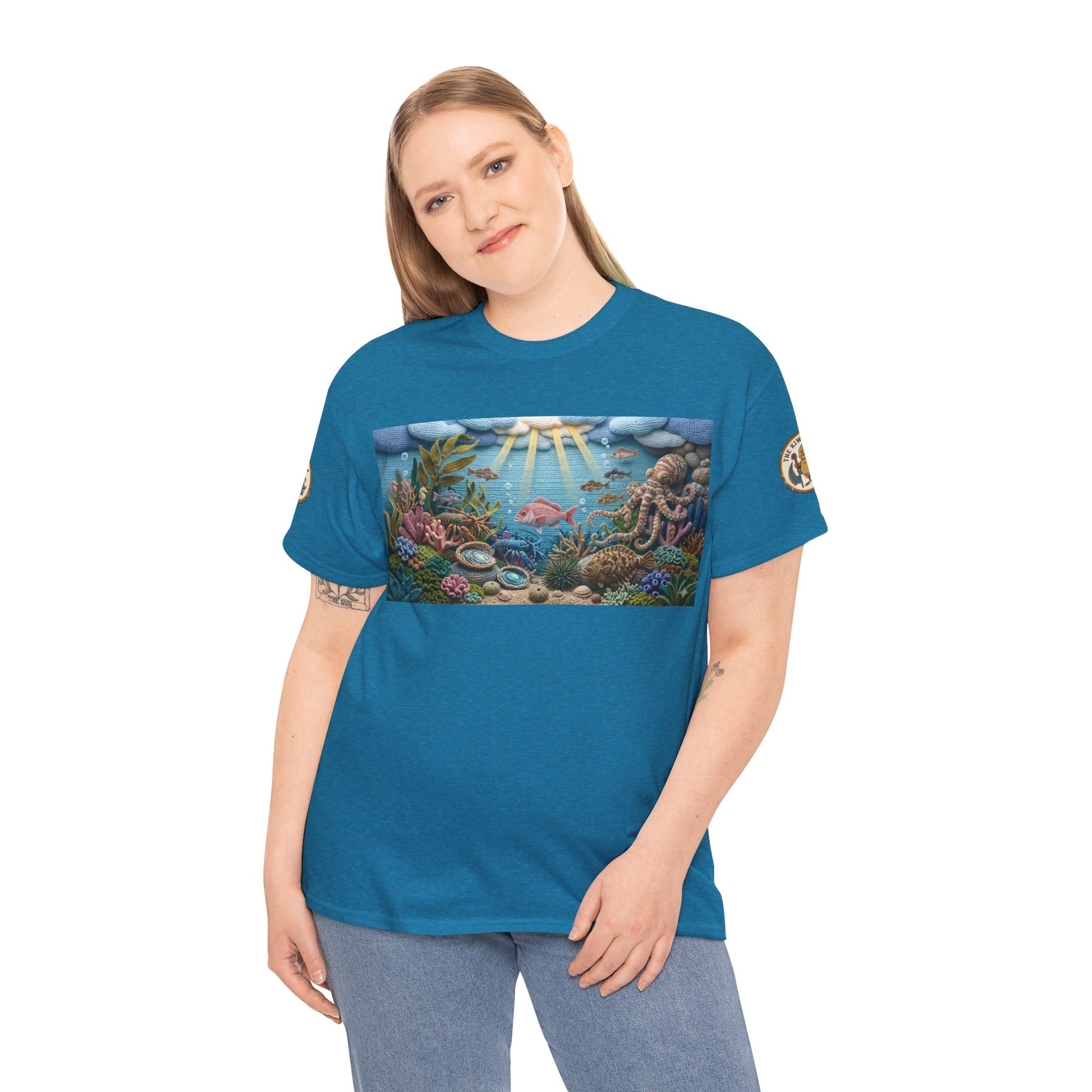 Teal/blue ocean graphic T-shirt on model with reef artwork and sleeve patch details