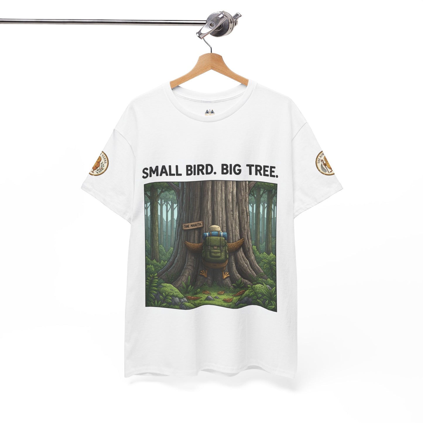 White T-shirt on hanger with front square forest scene graphic and “SMALL BIRD. BIG TREE.”