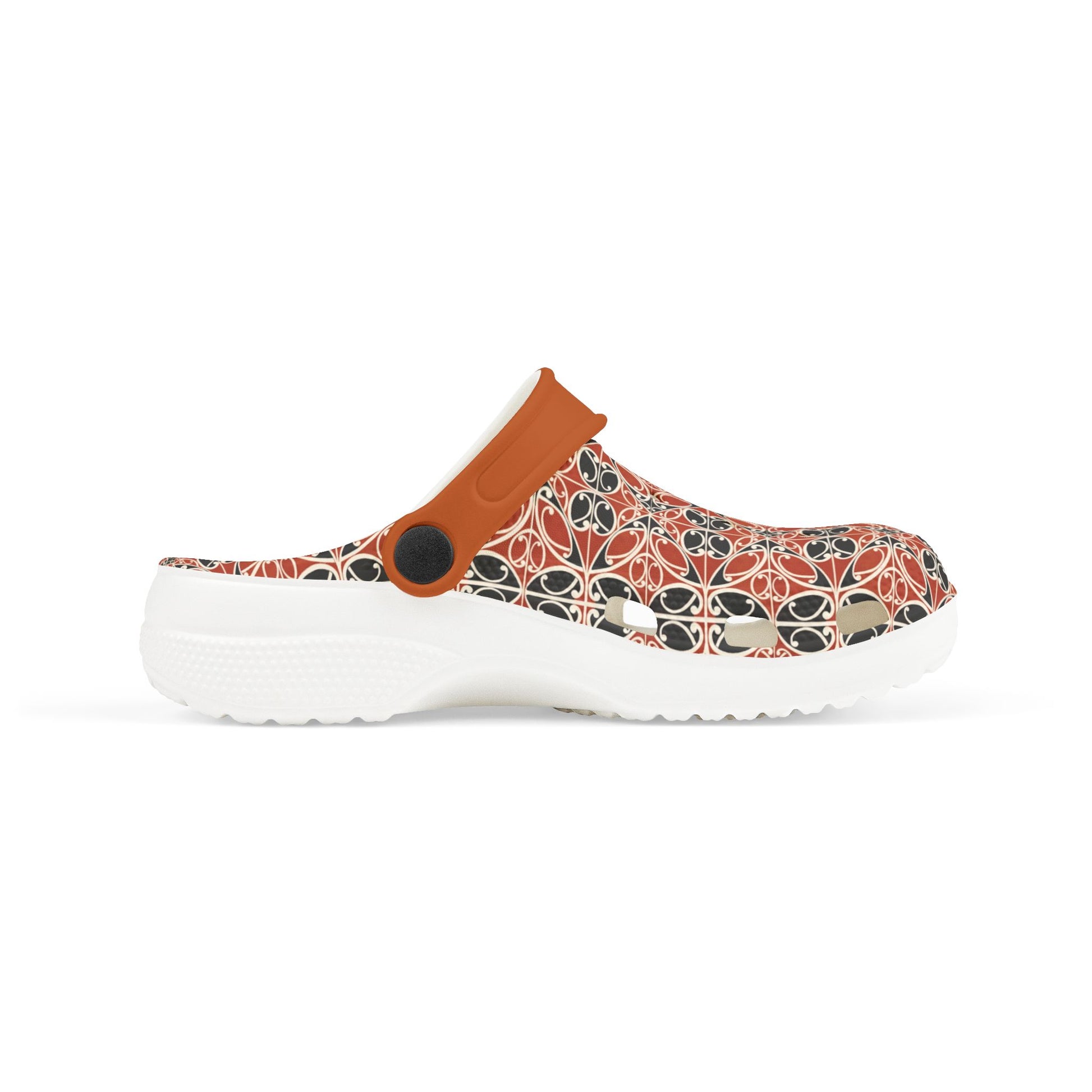 Māoritanga slide clogs side view with patterned upper, tan strap, and black circular detail