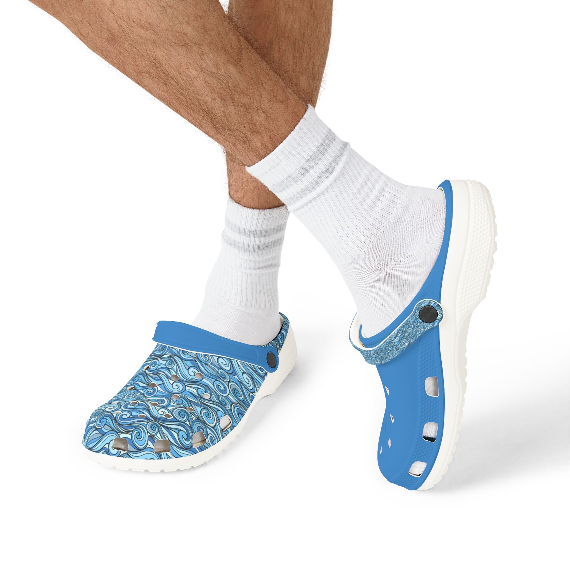 Blue and patterned slip-on clogs on feet with white crew socks